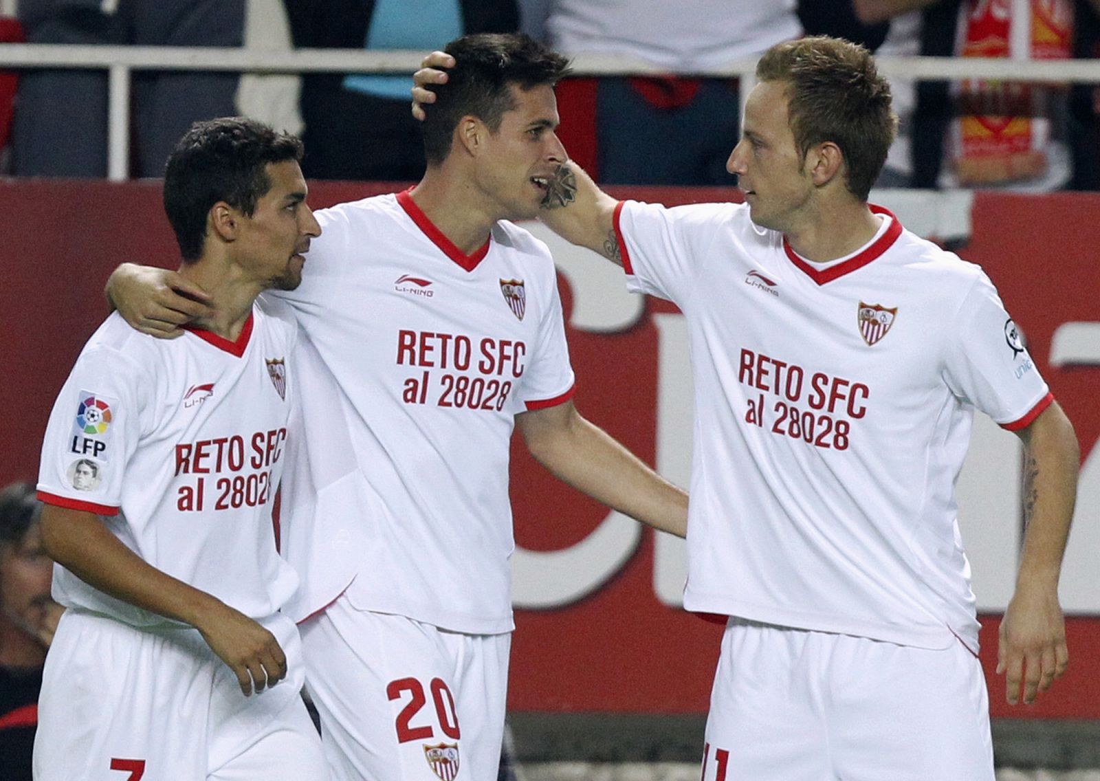 Sevilla's Manu del Moral is congratulated by teammates after scoring against Granada in Seville