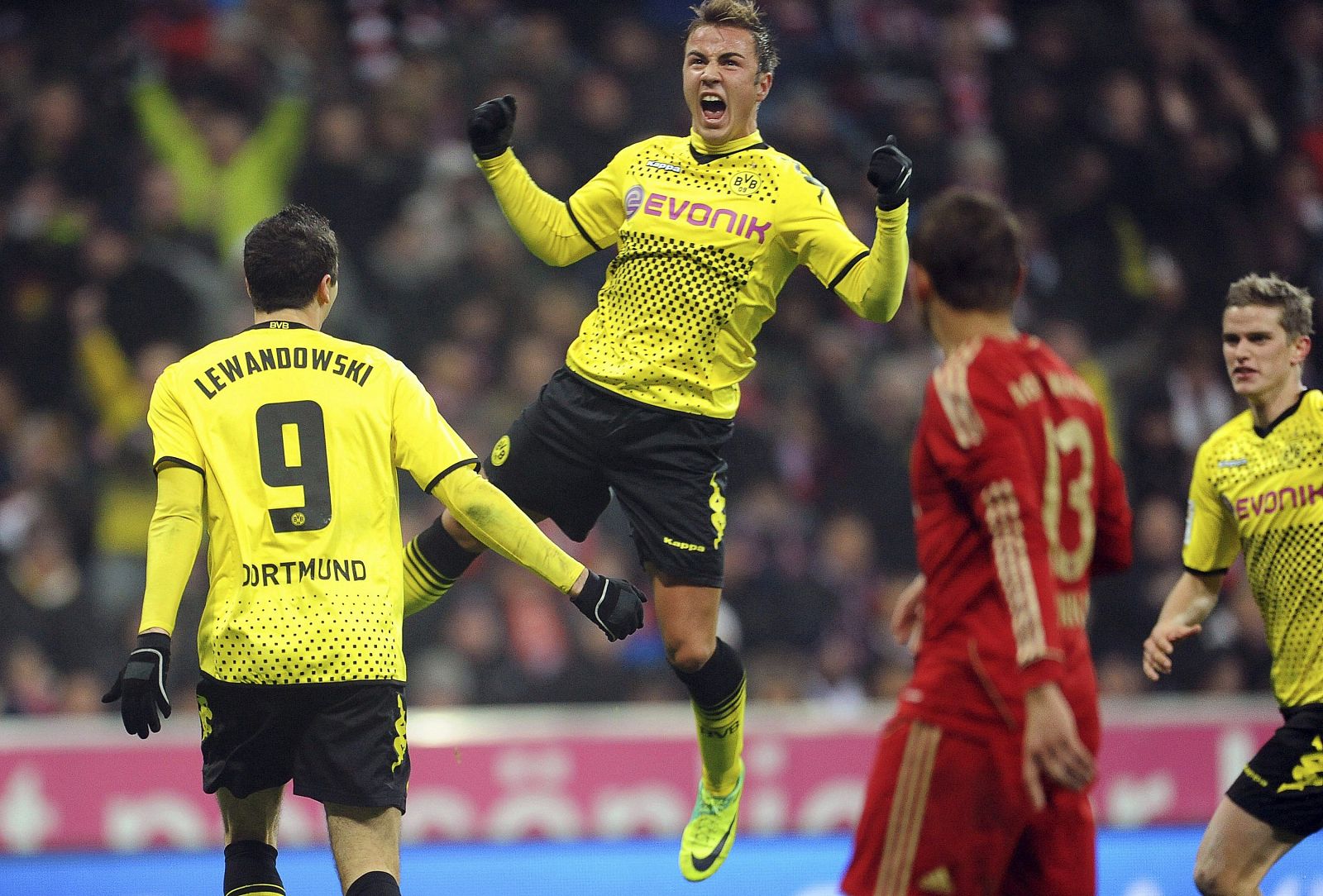 Mario Goetze del Borussia Dortmund (c) celebra con su compañero Robert Lewandowski (i) el 1-0 al Bayern Munich.
