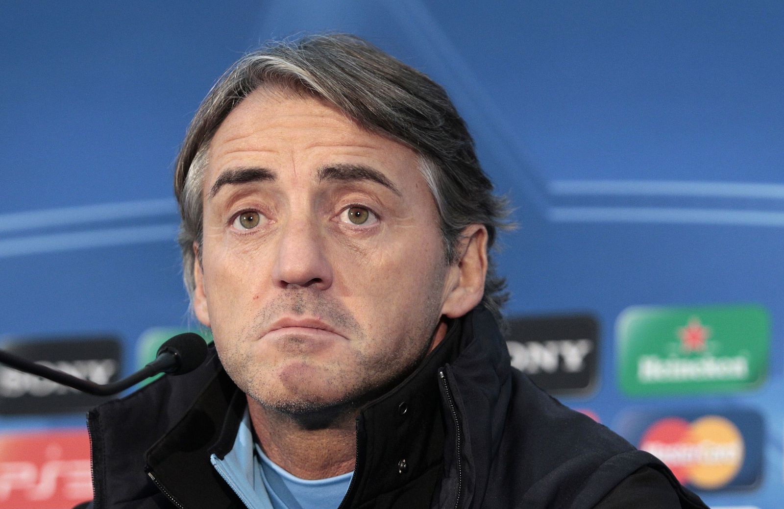 Manchester City's coach Roberto Mancini gestures during a news conference at the club's Carrington training complex in Manchester, northern England