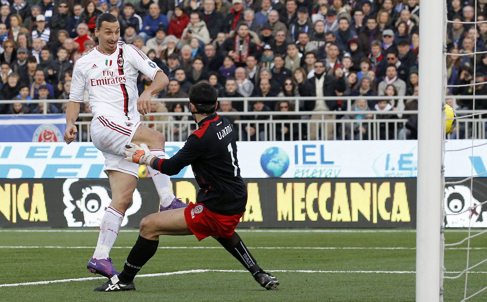 AC Milan's Ibrahimovic shoots to score past Novara's Ujkani during their Italian Serie A soccer match in Novara