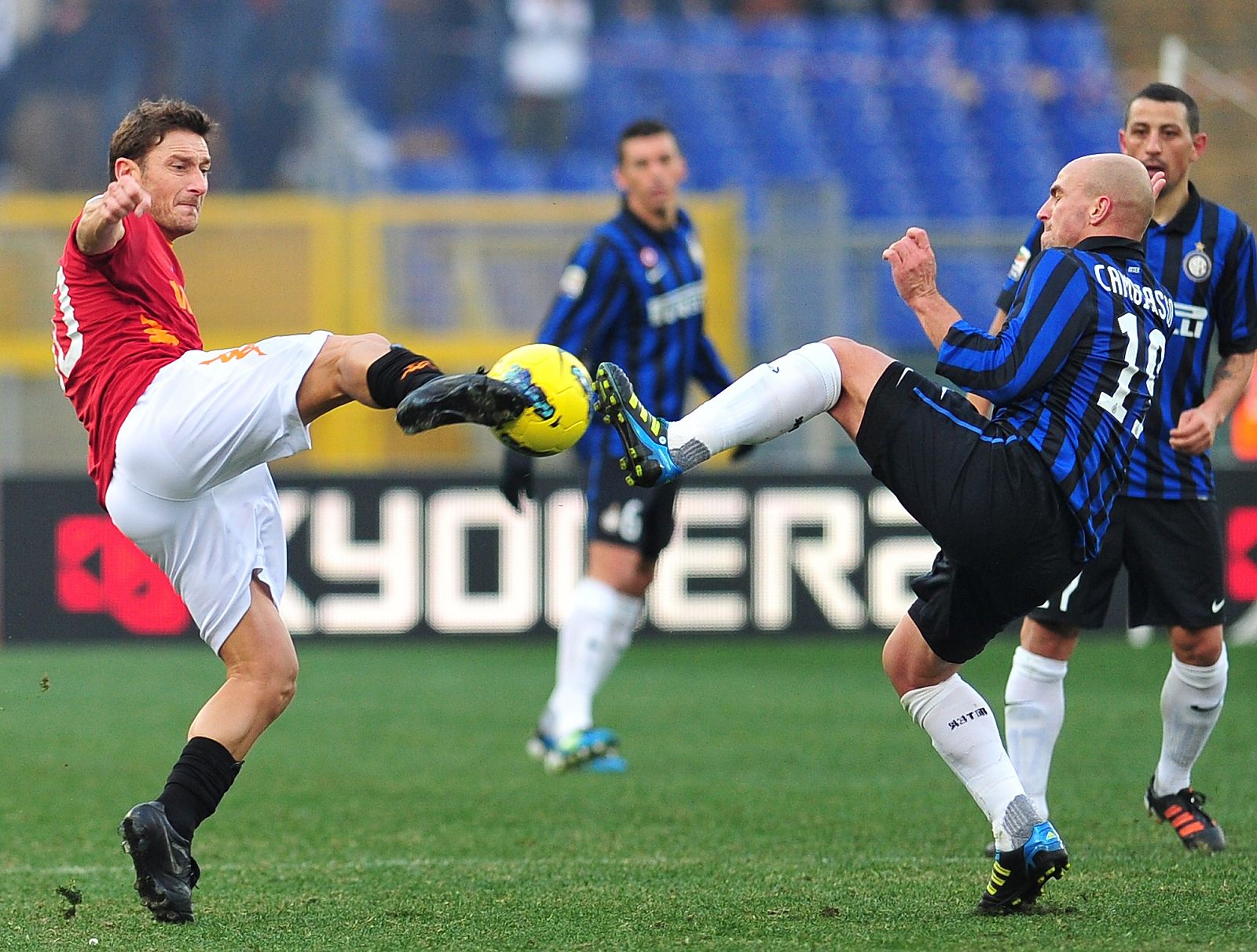 Totti y Cambiasso pugnan por el esférico.