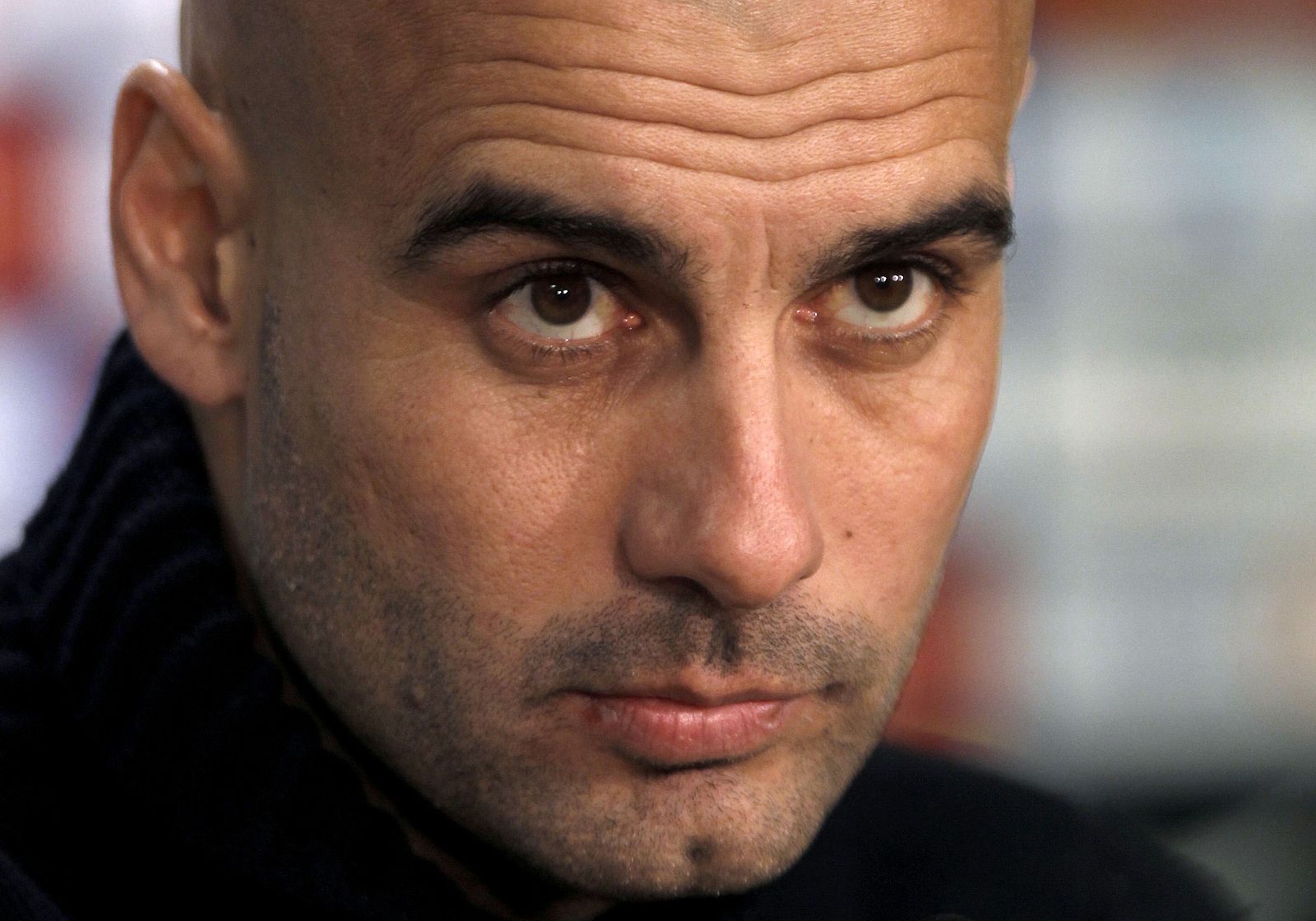 Barcelona's coach Pep Guardiola listens to a question during a news conference before their semi-final second leg soccer match against Valencia near Barcelona