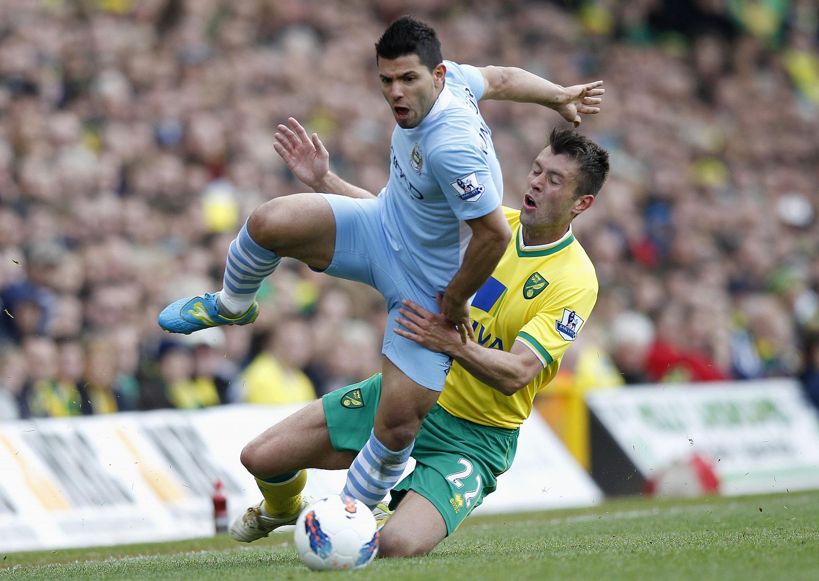 Aguero of Manchester City evades a tackle from Ward of Norwich City during their English Premier League soccer match in Norwich, eastern England