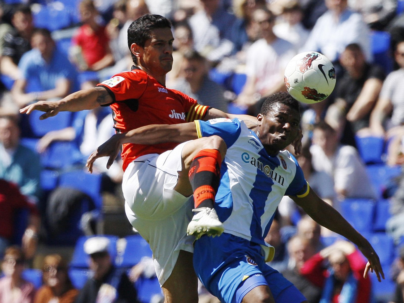 Espanyol's Uche fights for the ball with Valencia's Costa during their Spanish First division soccer league match near Barcelona