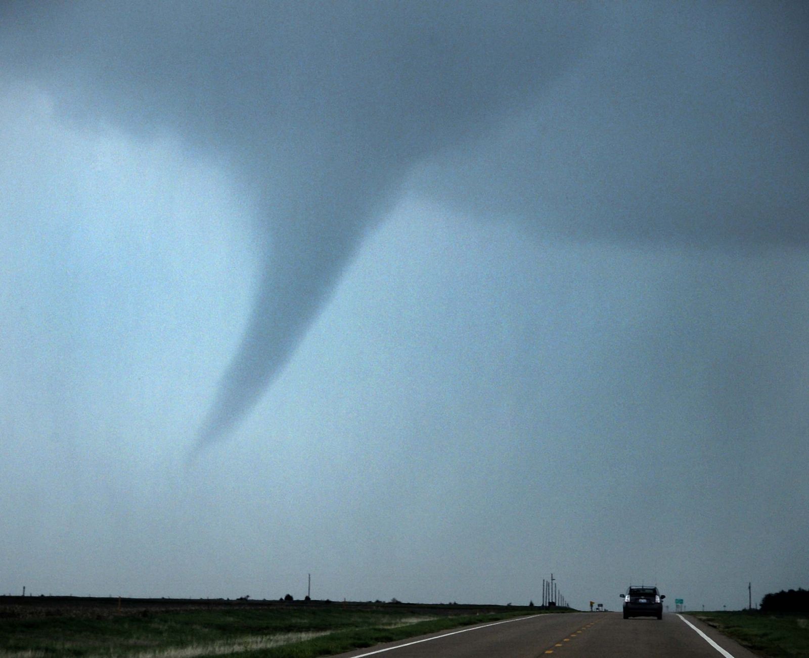 A tornado makes its way through farmlands near Rush Center