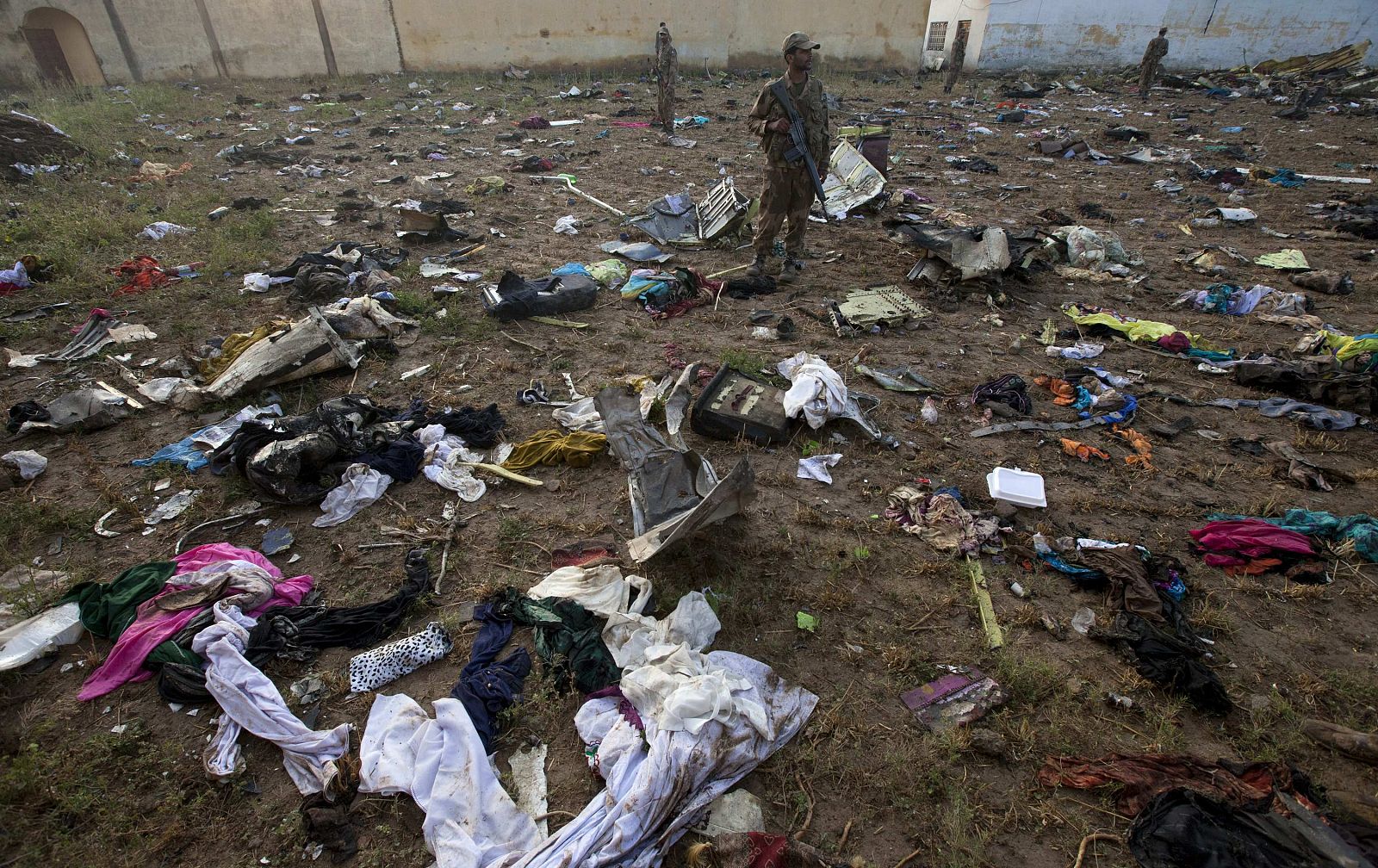 Soldiers stand amid the wreckage of a Boeing 737 airliner that crashed in Islamabad