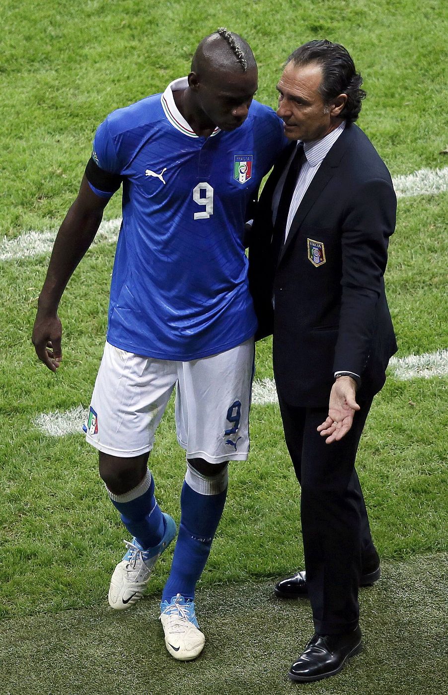 Italy's coach Prandelli talks to Balotelli after leaving the pitch during their Euro 2012 semi-final soccer match against Germany at the National Stadium in Warsaw