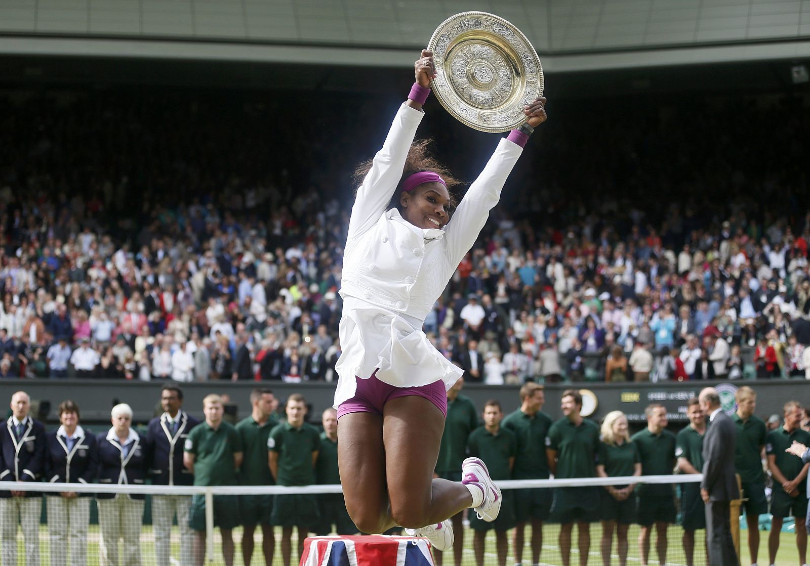 Serena Williams of the U.S. holds her trophy after defeating Agnieszka Radwanska of Poland in their women's final tennis match at the Wimbledon tennis championships in London