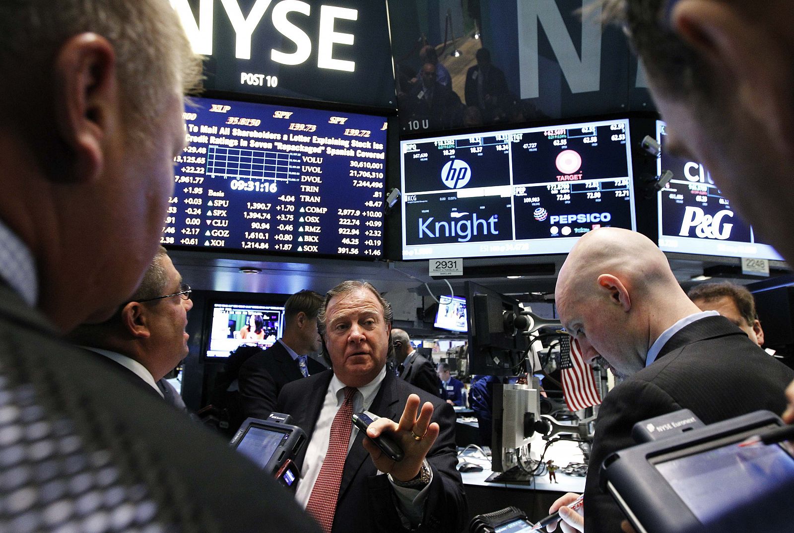 Traders gather at the Barclays Capital post that trades Knight Capital on the floor of the New York Stock Exchange