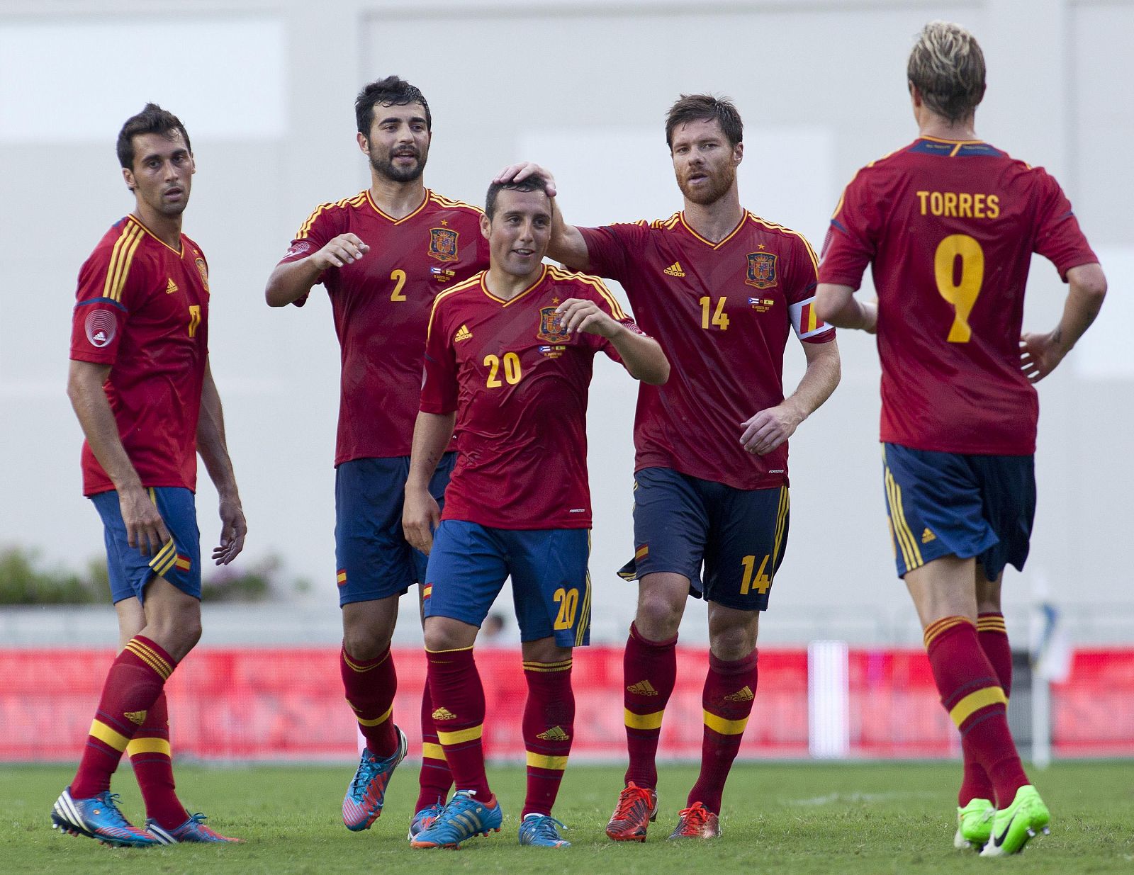 Spain's Cazorla celebrates with teammates after scoring the first goal against Puerto Rico's national team during a friendly soccer match at the Juan Ramon Loubriel Stadium in Bayamon