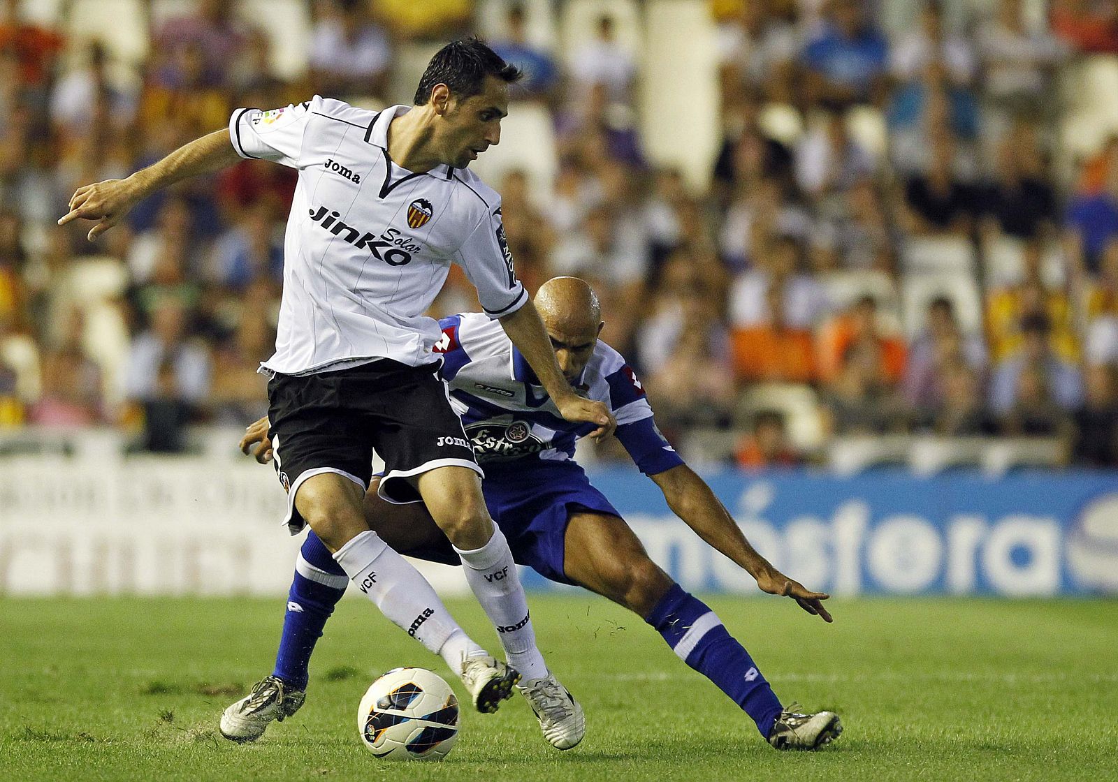 Valencia's Jonas and Deportivo Coruna's Pablo fight for the ball during their Spanish first division soccer match in Valencia