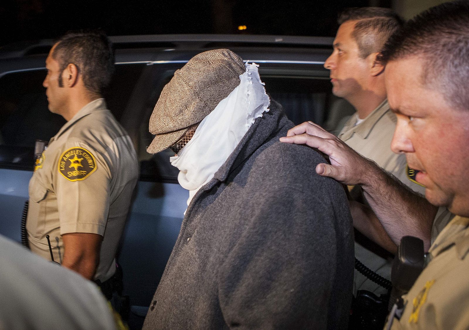 Nakoula Basseley Nakoula is escorted out of his home by Los Angeles County Sheriff's officers in Cerritos, California