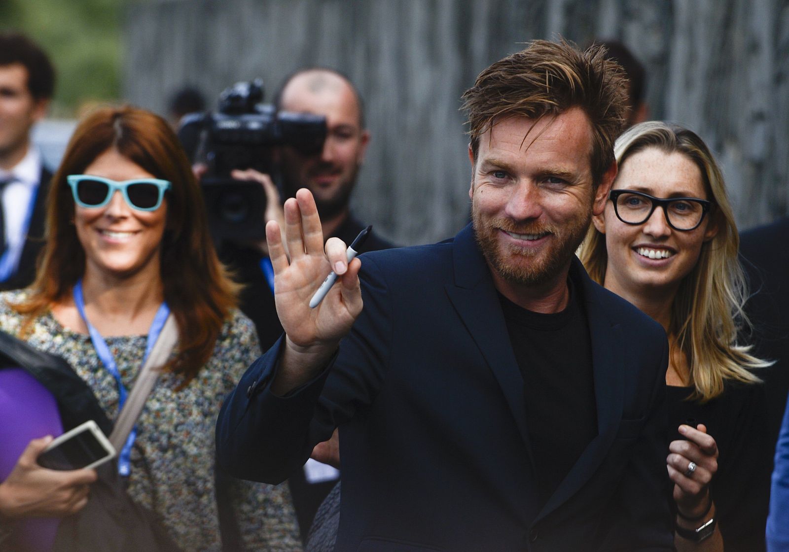 Actor McGregor waves to fans after photocall to promote movie "The Impossible" on the seventh day of the 60th San Sebastian Film Festival
