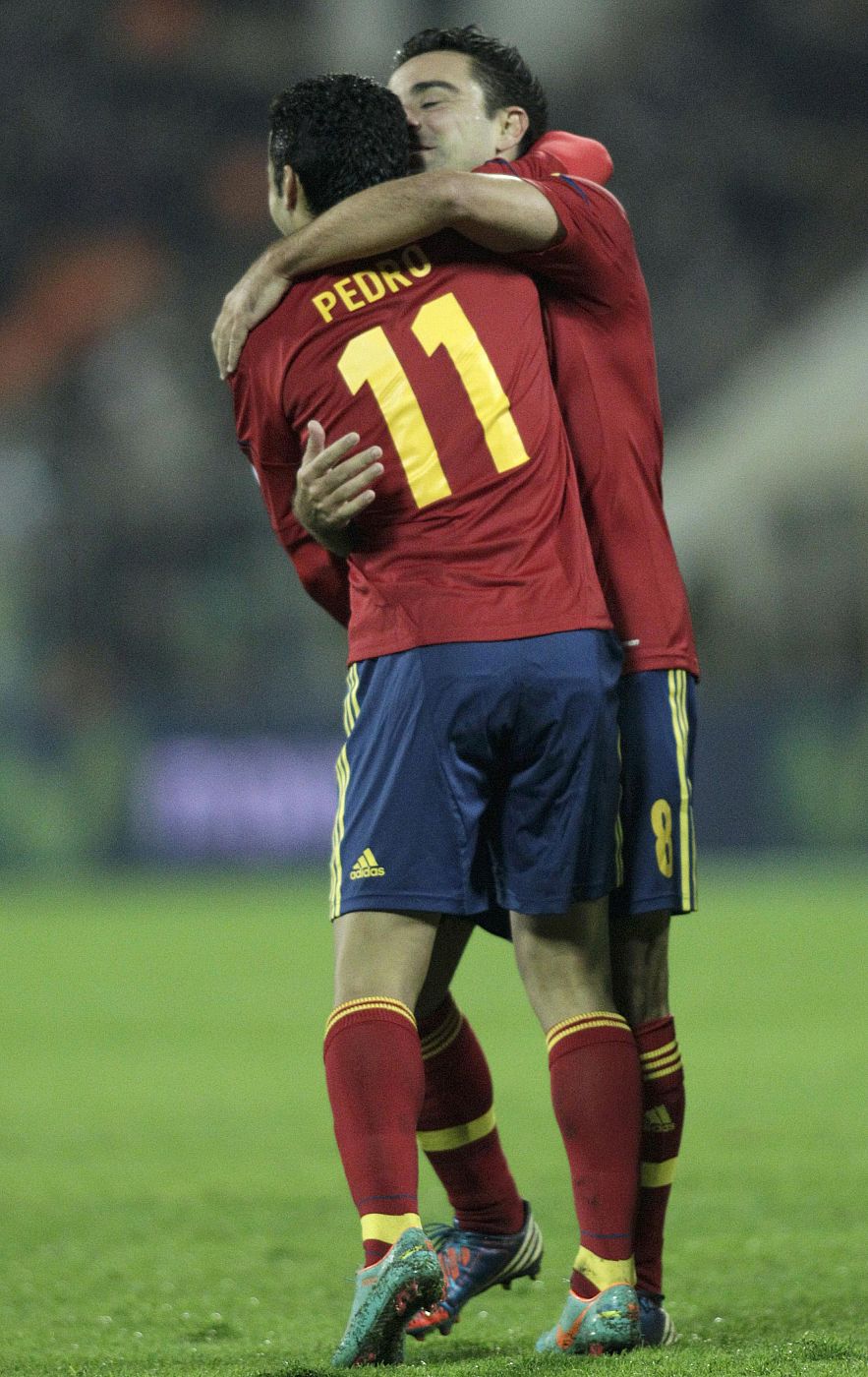 Spain's Pedro celebrates with teammate Xavi after scoring a goal against Belarus during their 2014 World Cup qualifying soccer match in Minsk