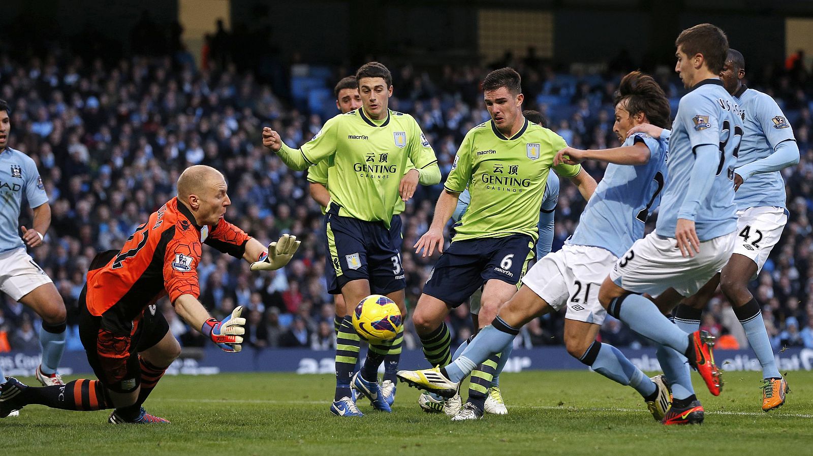 Manchester City's David Silva shoots past Aston Villa's Brad Guzan to score during their English Premier League soccer match in Manchester