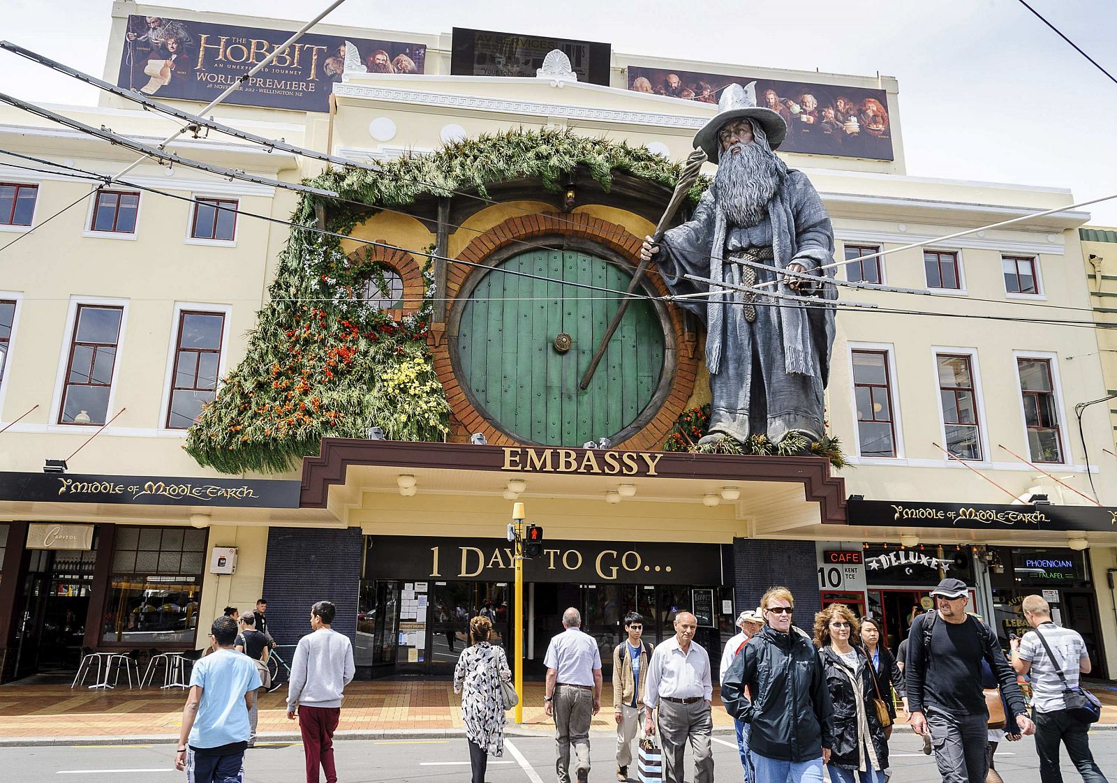 Pedestrians walk past a giant model of Gandalf mounted on the front of The Embassy Theatre in Wellington
