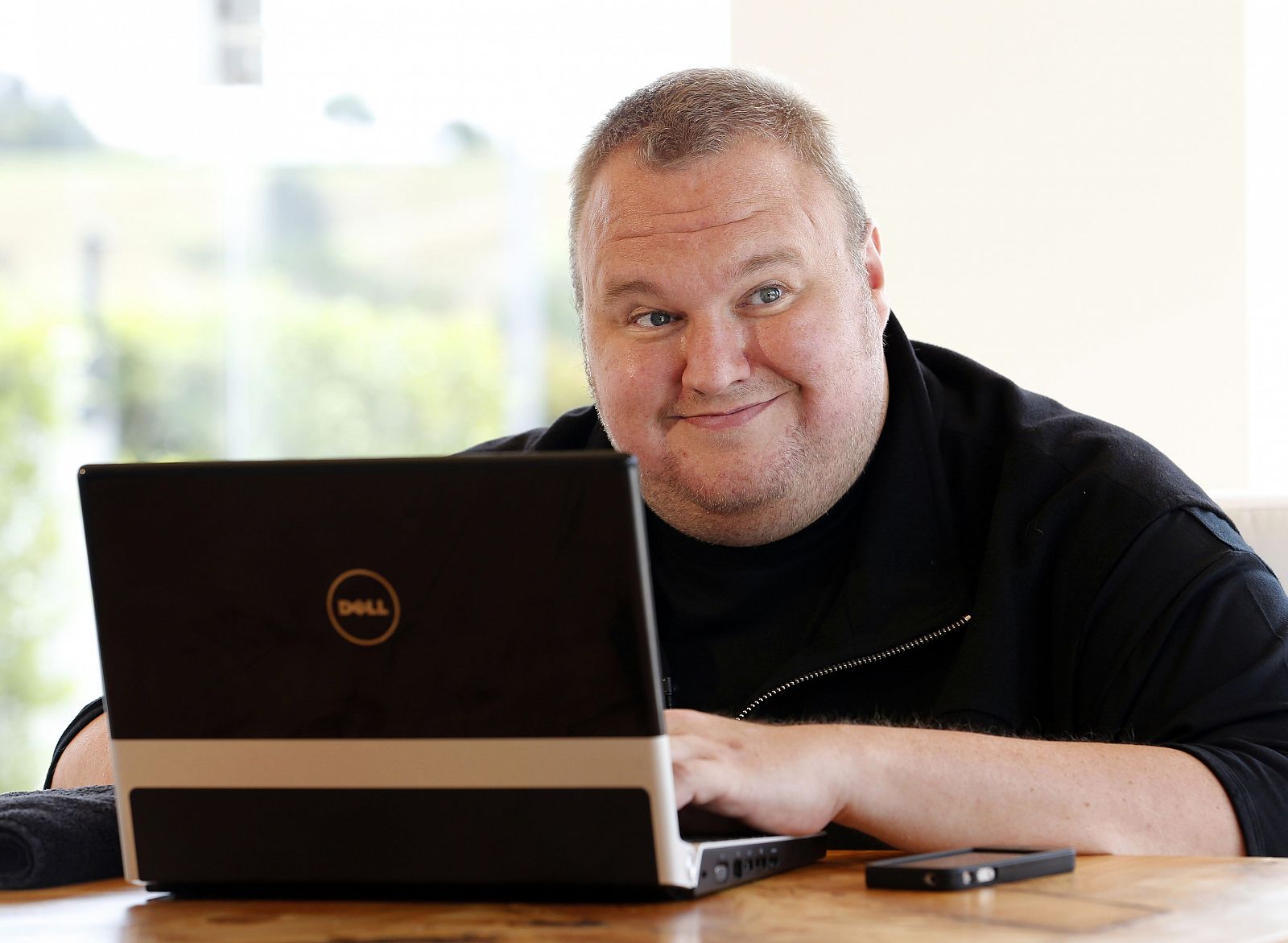 Kim Dotcom smiles during an interview with Reuters in Auckland