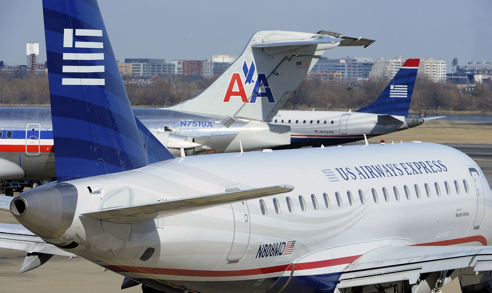 An American Airlines plane is seen between two US Airways Express planes at the Ronald Reagan Washington National Airport in Virginia