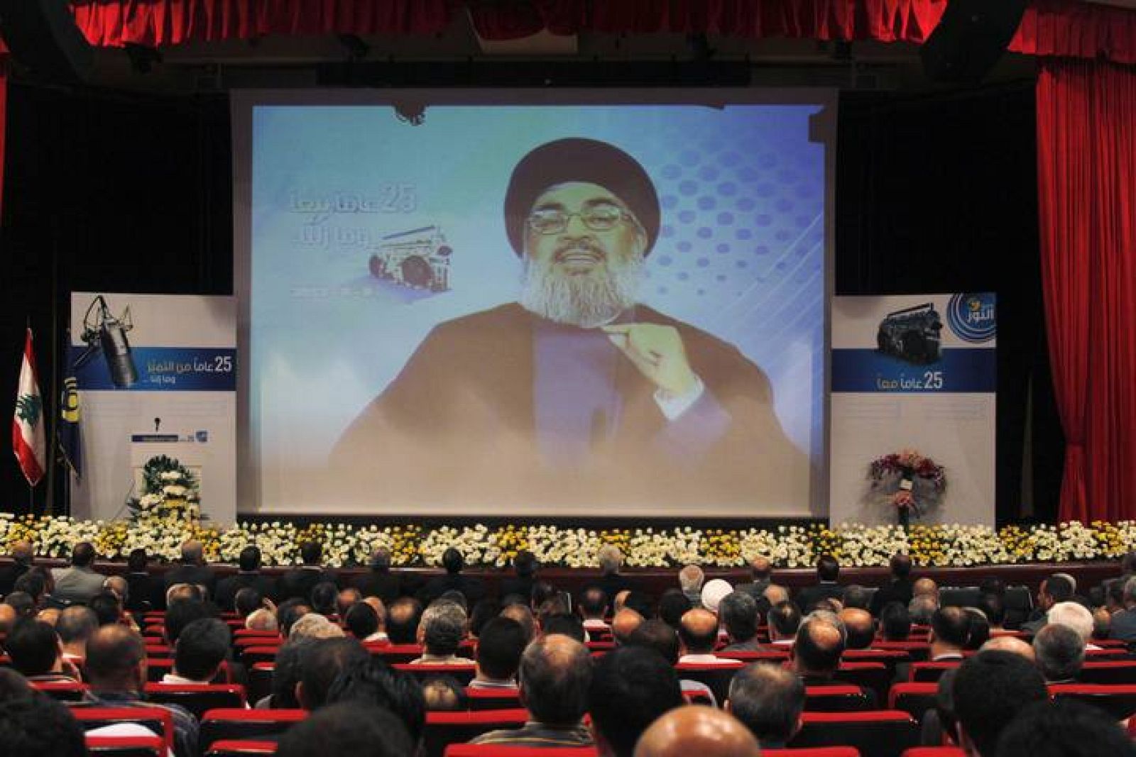Lebanon's Hezbollah leader Nasrallah is projected on a screen during a live broadcast at an event marking the 25th anniversary of the establishment of Al-Nour radio station in Beirut