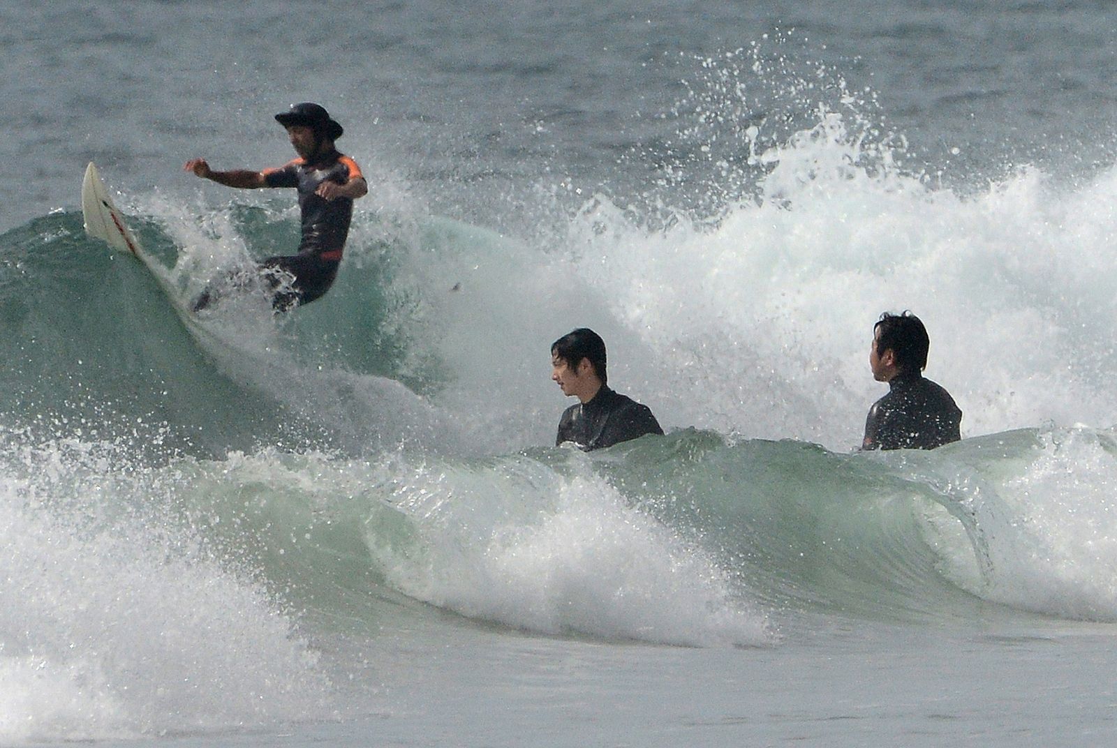 Surferos en una playa a 50 km de la central nuclear de Fukushima.