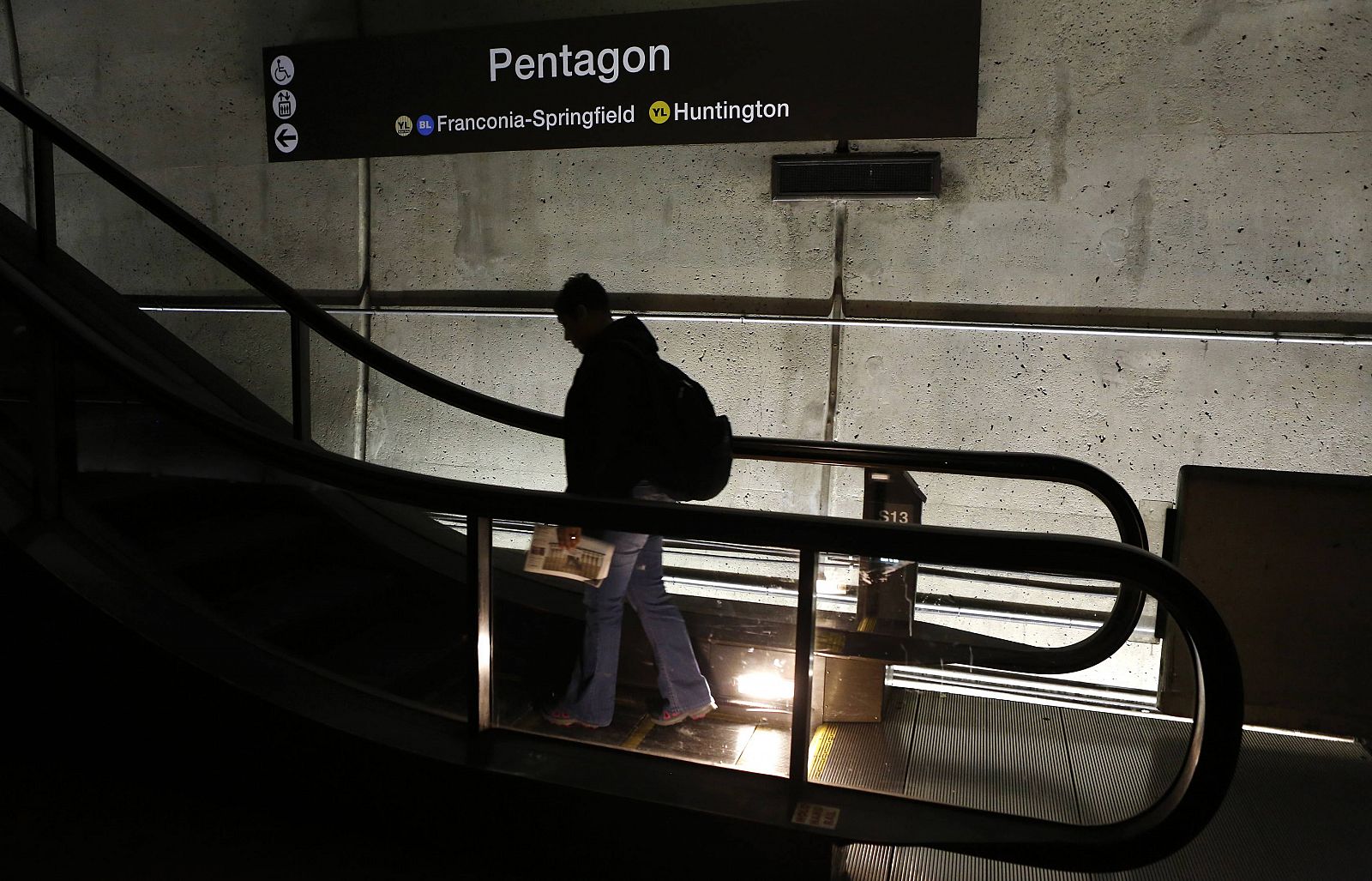 A man rides an upward escalator at the Pentagon Metro station in Washington