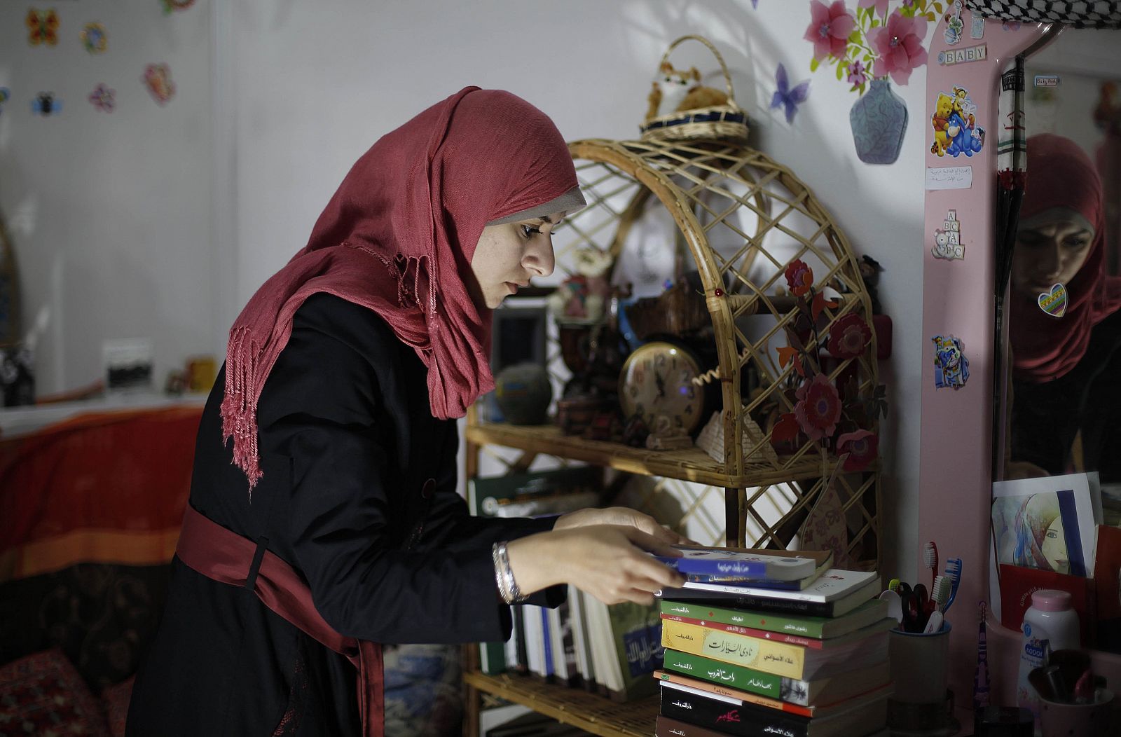 Isra Al-Modallal, a spokeswoman of the Hamas government in Gaza, prepares herself before heading to the office, at her house in Rafah refugee camp