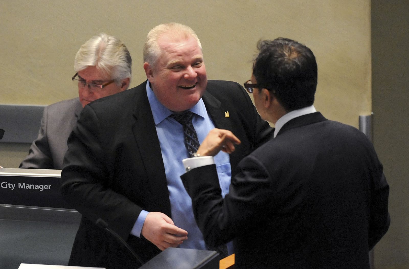 Toronto Mayor Rob Ford speaks with Councillor Denzil Minnan-Wong during a city council meeting in Toronto