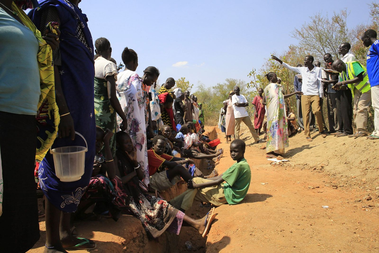 Families displaced by recent fighting in South Sudan, gather to be registered to receive dry food rations at a makeshift camp in Jabel