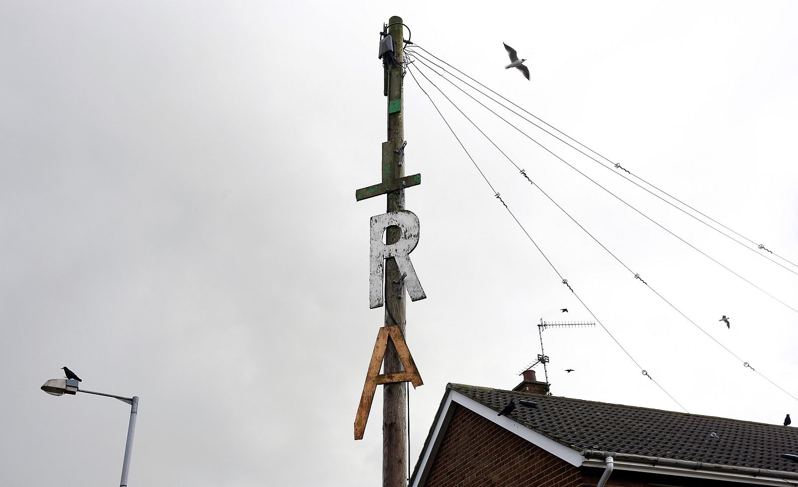 An Irish Republican Army (IRA) sign is seen nailed to a telegraph pole in the Kilwilkie estate, near Lurgan in Northern Ireland