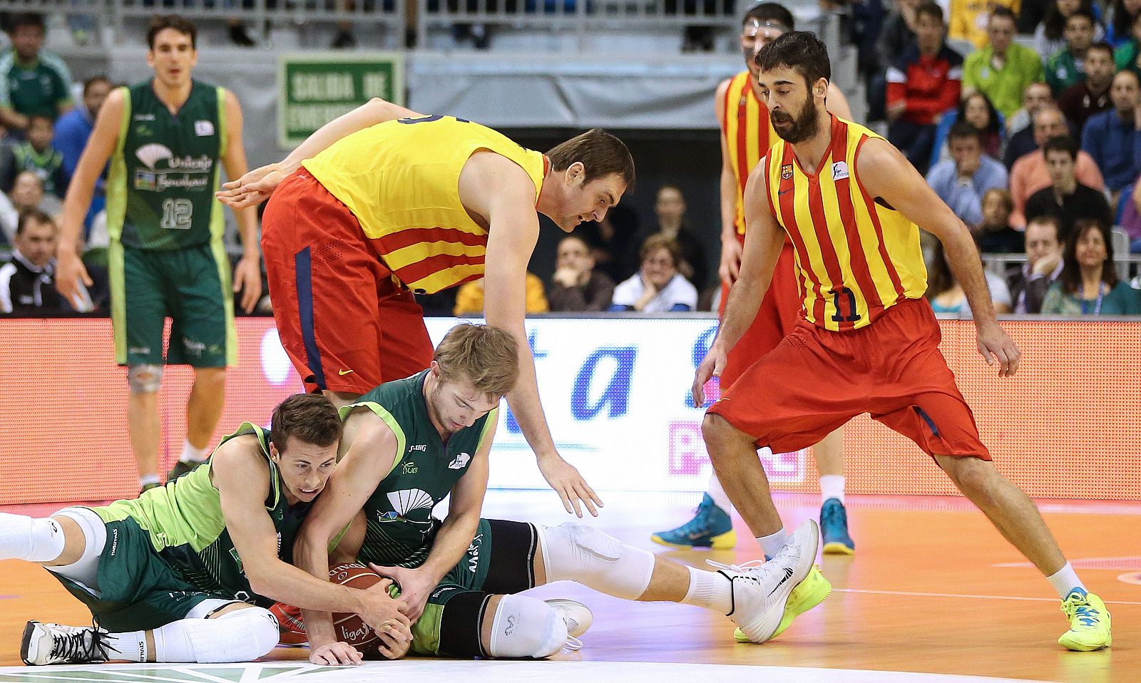 Los jugadores del Unicaja Ryan Toolson y Domas Sabonis retienen el balón ante los jugadores del FC Barcelona Erazem Lorbek y Juan Carlos Navarro.