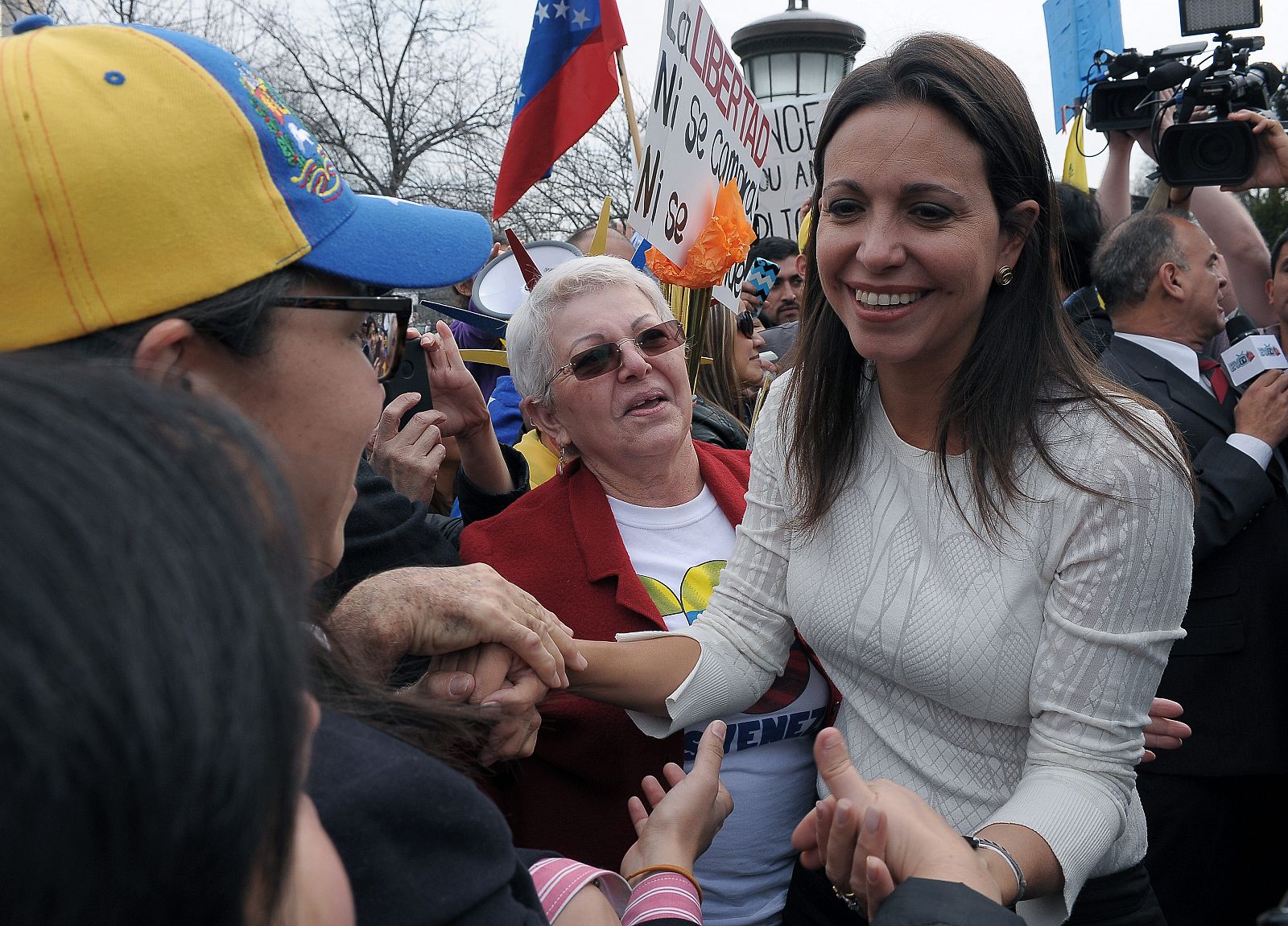 La diputada opositora venezolana María Corina Machado saluda a varios opositores en una protesta