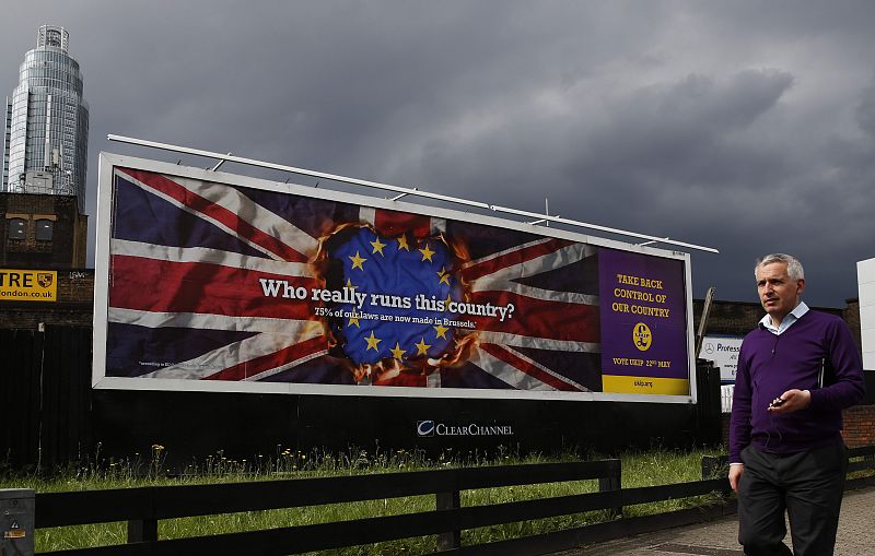 A pedestrian passes above a United Kingdom Independence Party European elections campaign poster in Vauxhall, central London