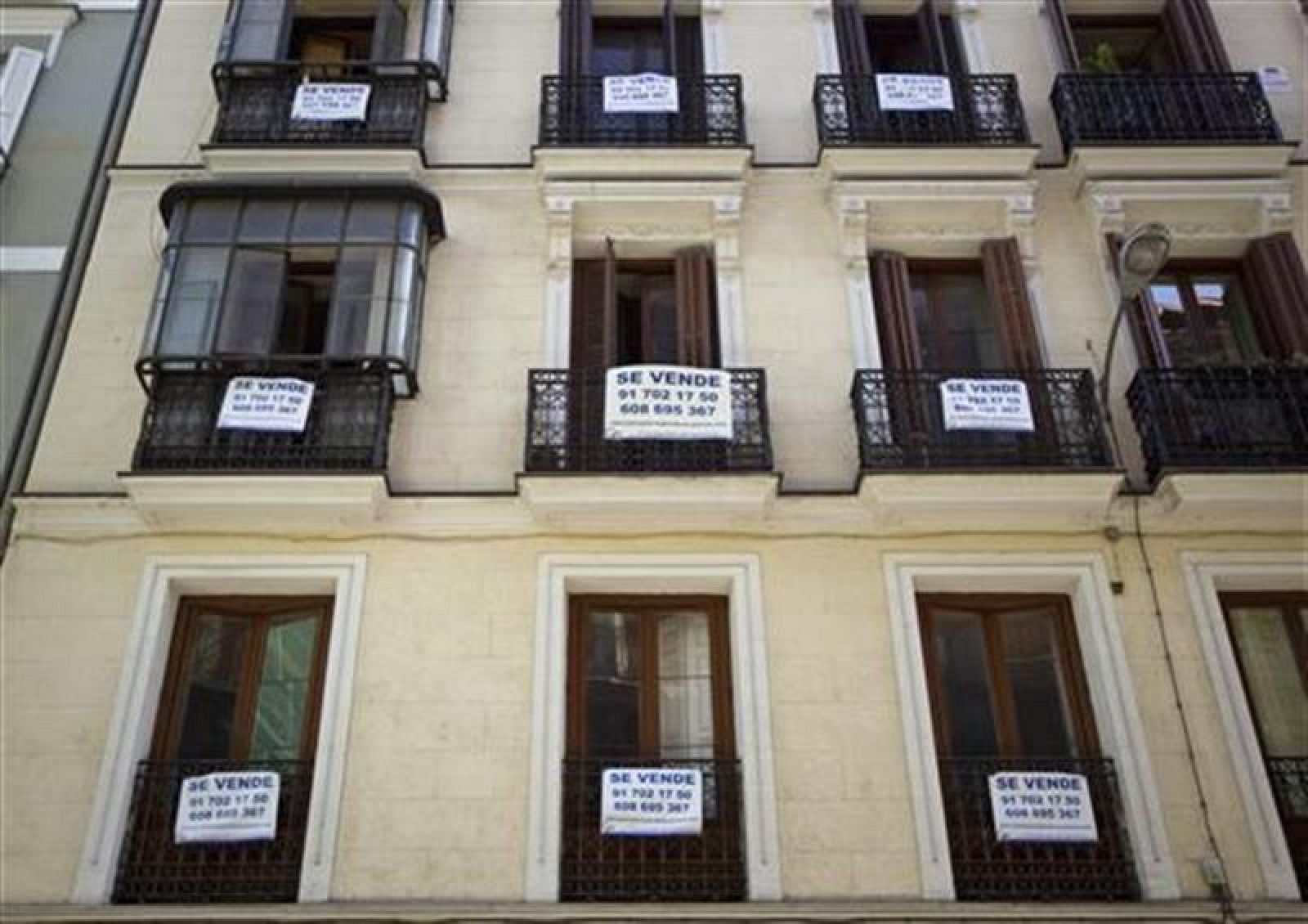 Carteles de venta en balcones de un bloque de pisos de Madrid