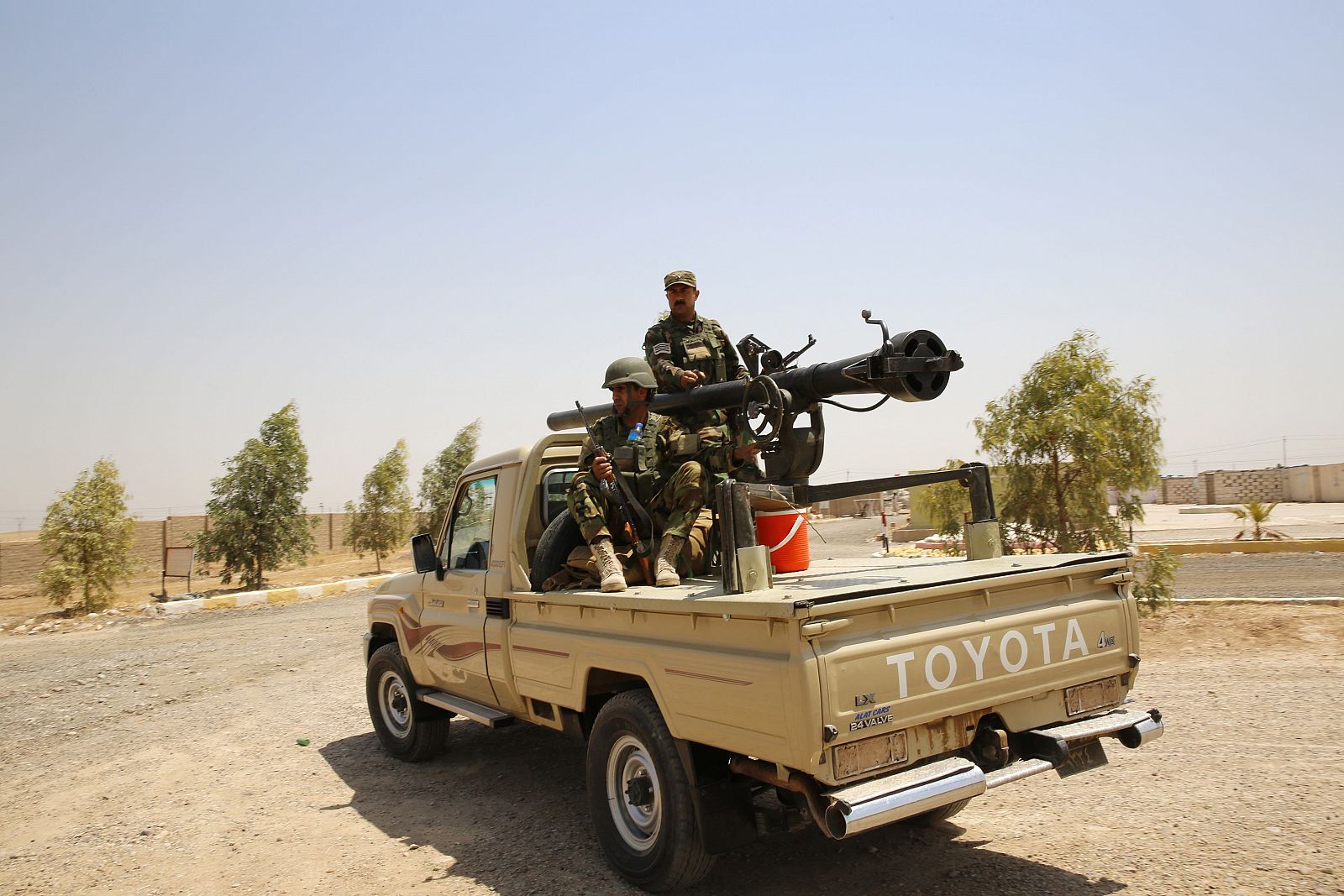 Members of Kurdish security forces keep guard during clashes with militants of the ISIL in Basheer