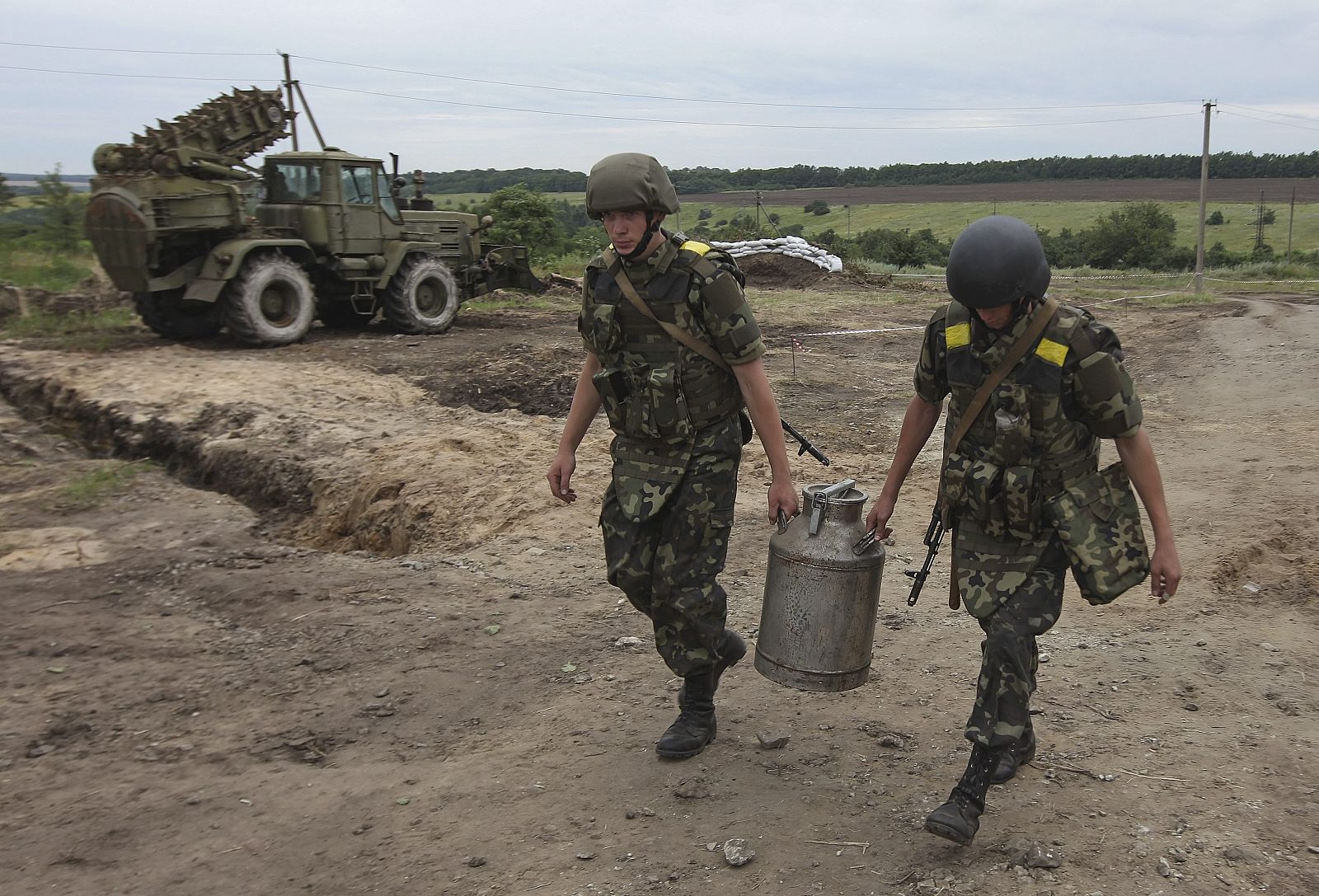 Soldados ucranianos cargan agua cerca a su campamento en Slaviansk (Ucrania)