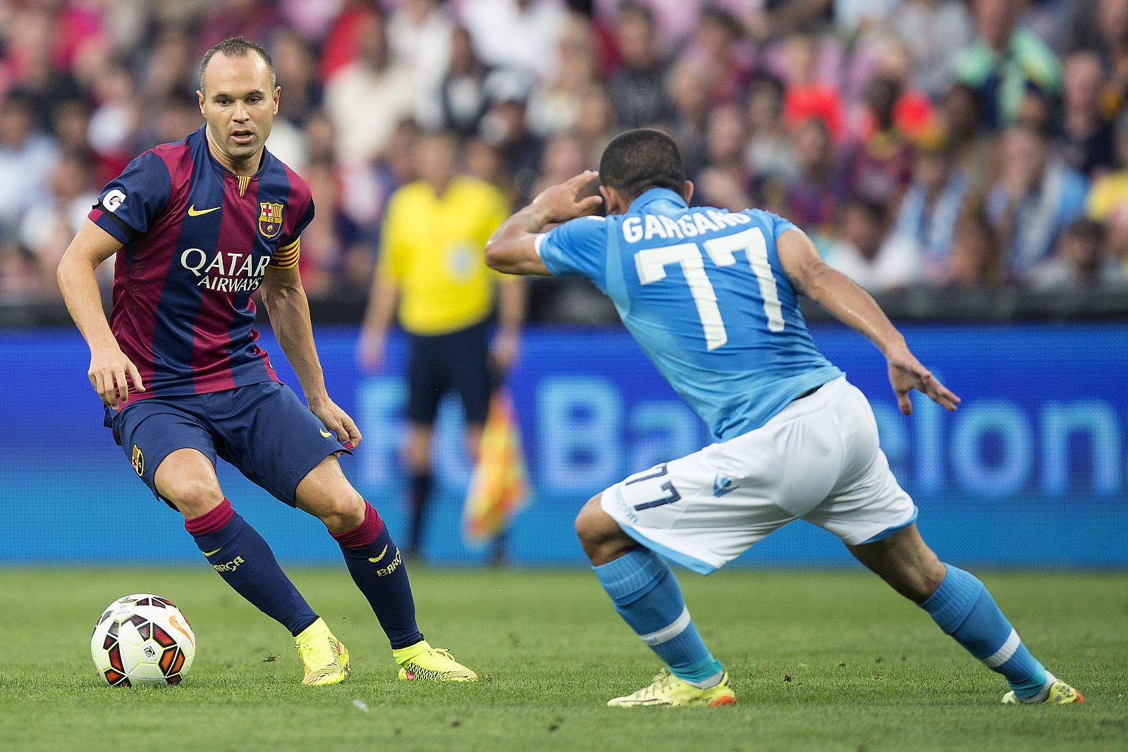 El jugador del FC Barcelona, Andrés Iniesta regatea al jugador del Nápoles, Walter Gargano.