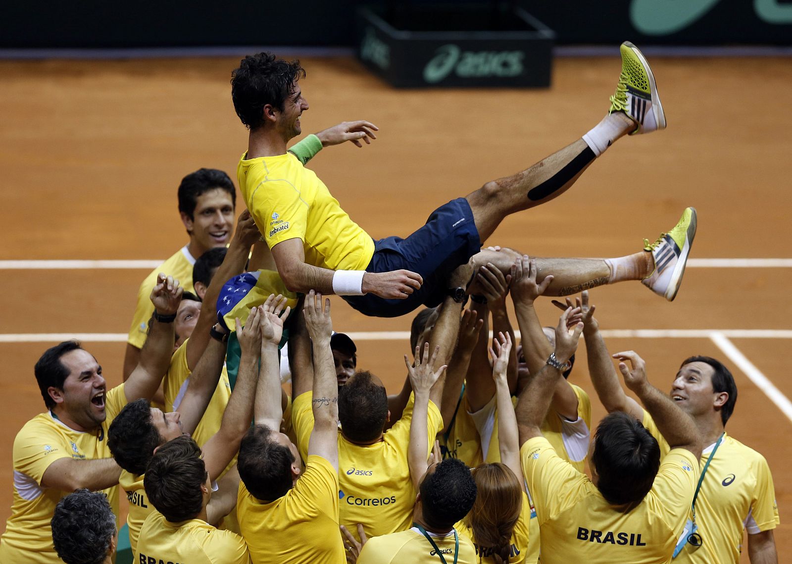 El brasileño Bellucci es manteado por sus compañeros tras el partido.