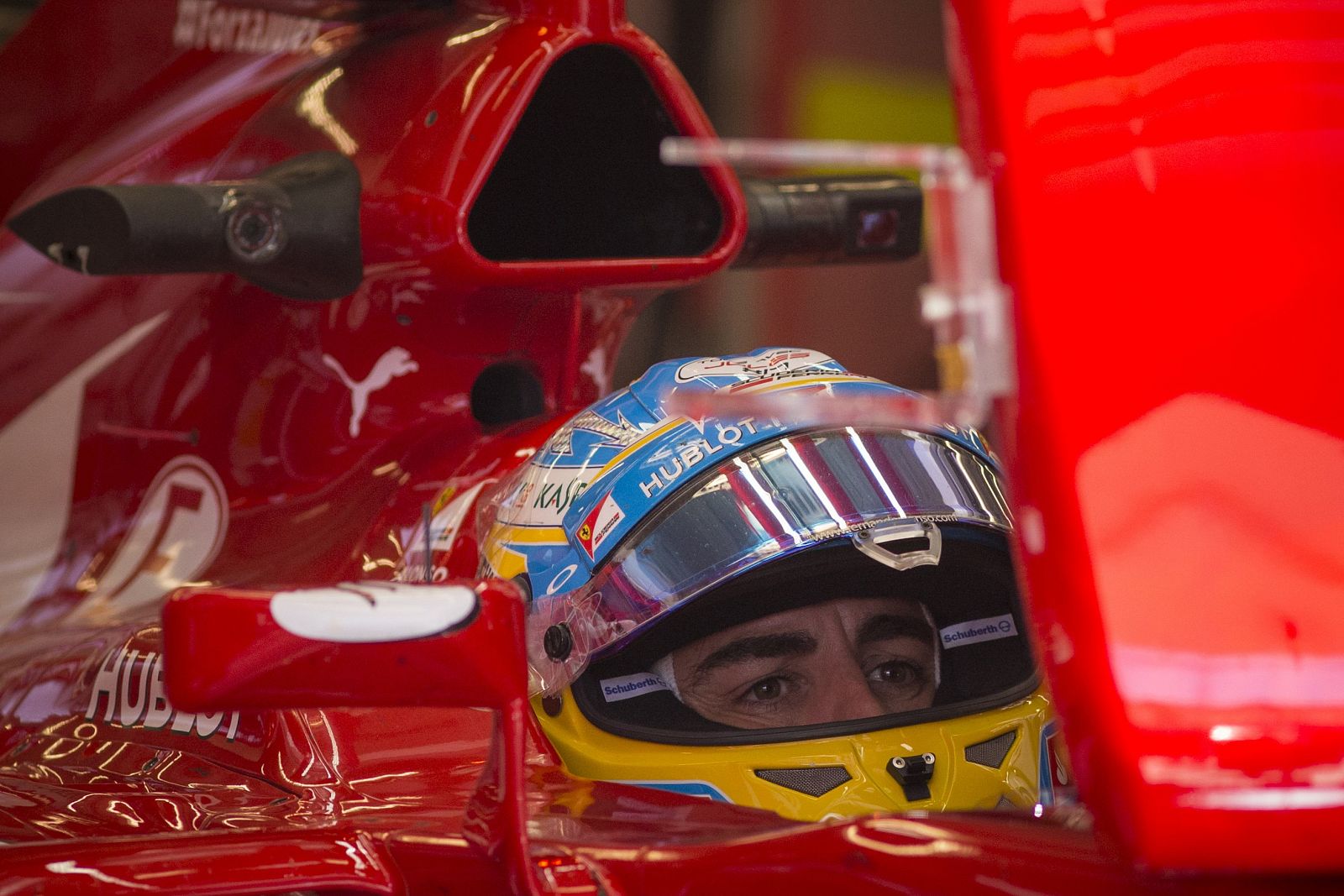 El piloto español, Fernando Alonso, preparado para la carrera en su coche de Ferrari.