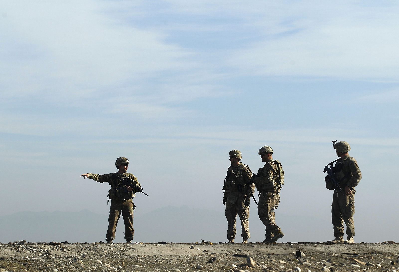 U.S. troops inspect at the site of a suicide attack on the outskirts of Jalalabad