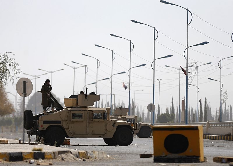 A member of the presidential guards stands on an armoured personnel carrier blocking a road leading to the presidential palace in Sanaa