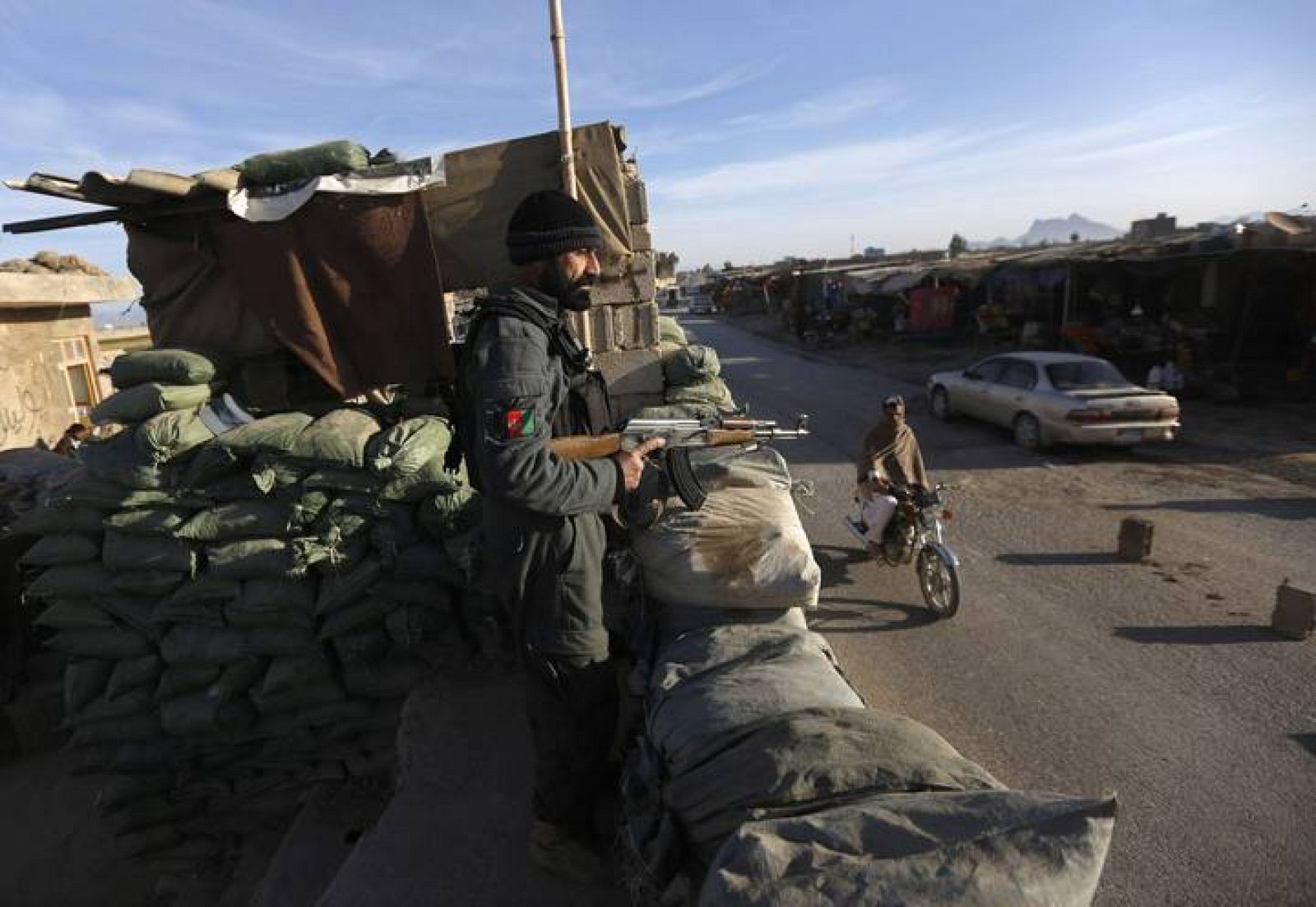 Policeman keeps watch at a checkpoint on the outskirts of Farah province