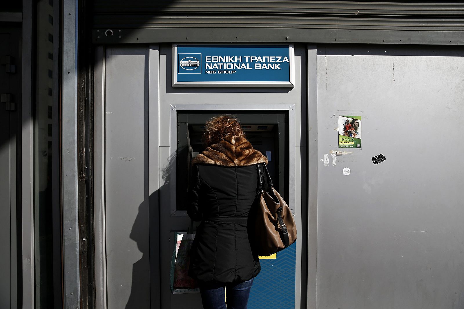 Una mujer retira dinero de un cajero del Banco Nacional de Grecia