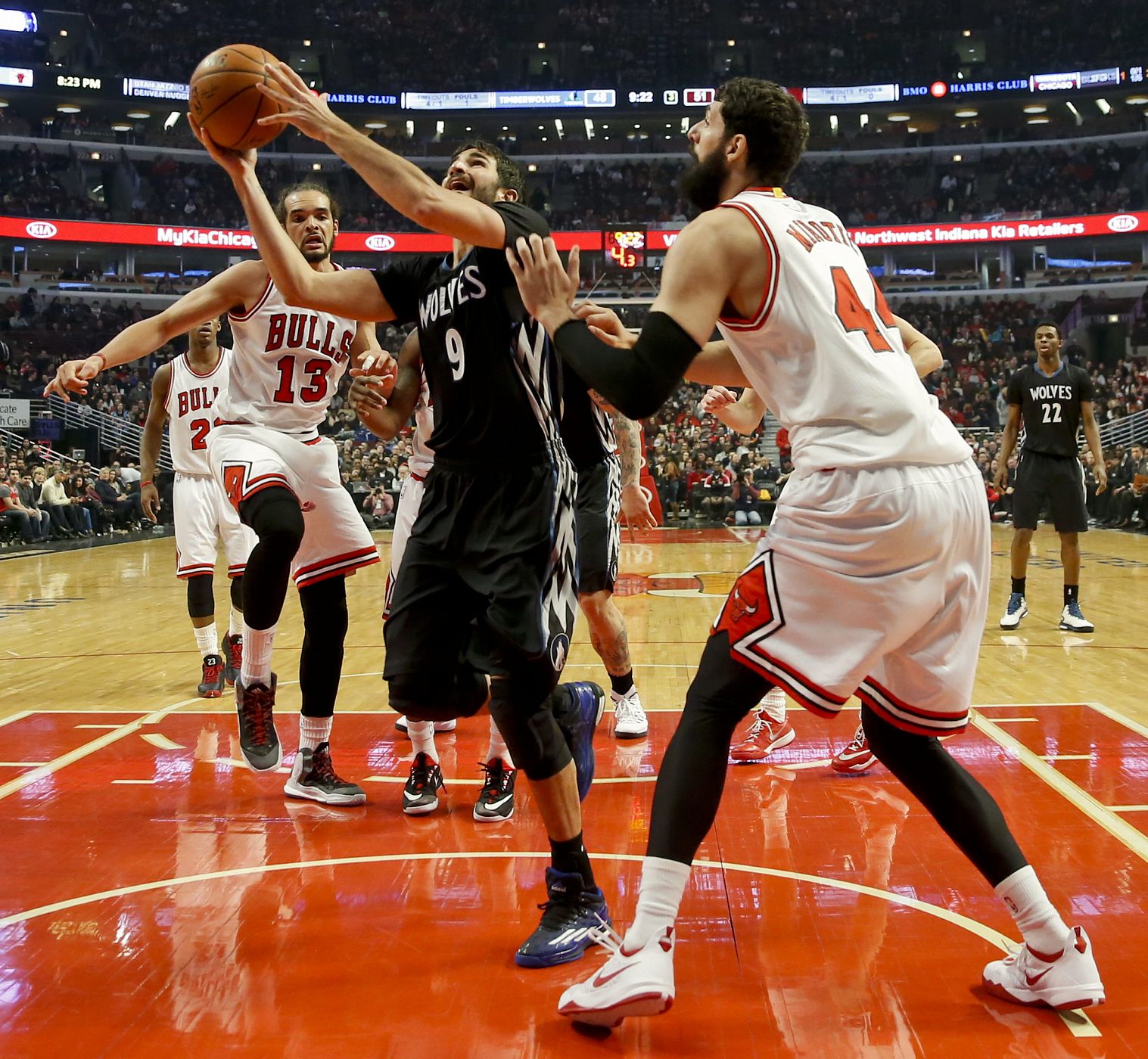 Ricky Rubio salta para encestar junto a Nikola Mirotic.