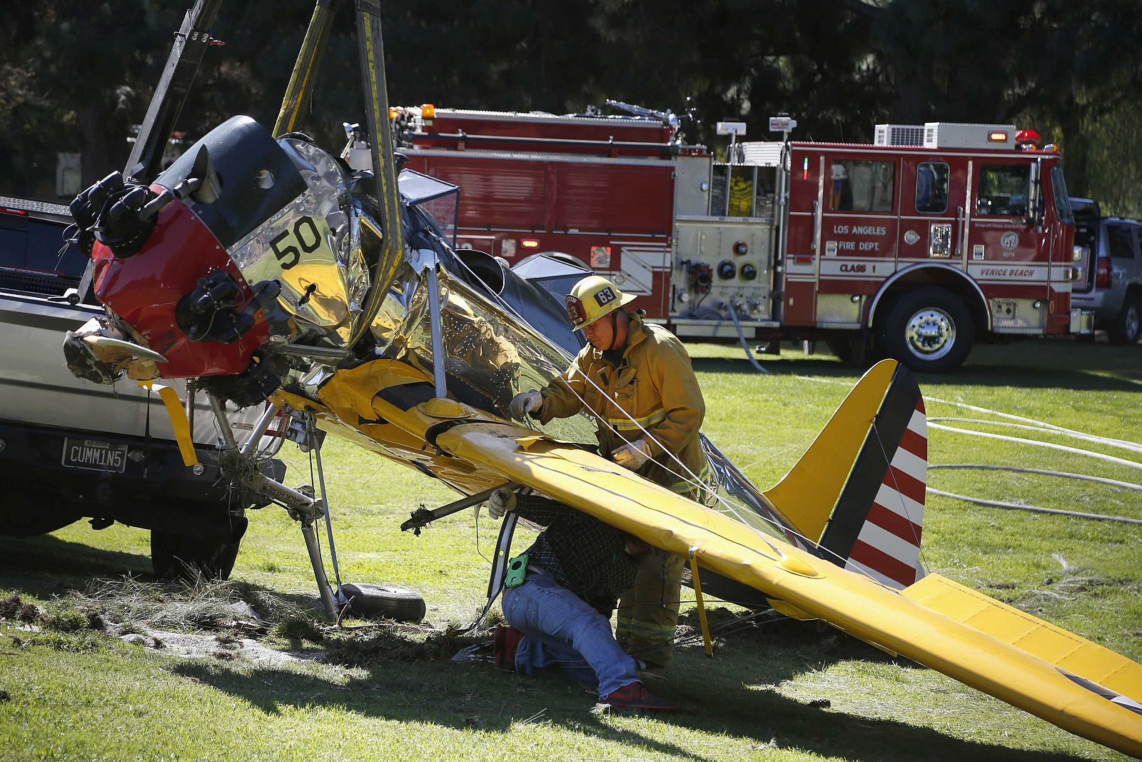 Actor Harrison Ford's damaged airplane is taken away after its crash landing at Penmar Golf Course in Venice, Los Angeles