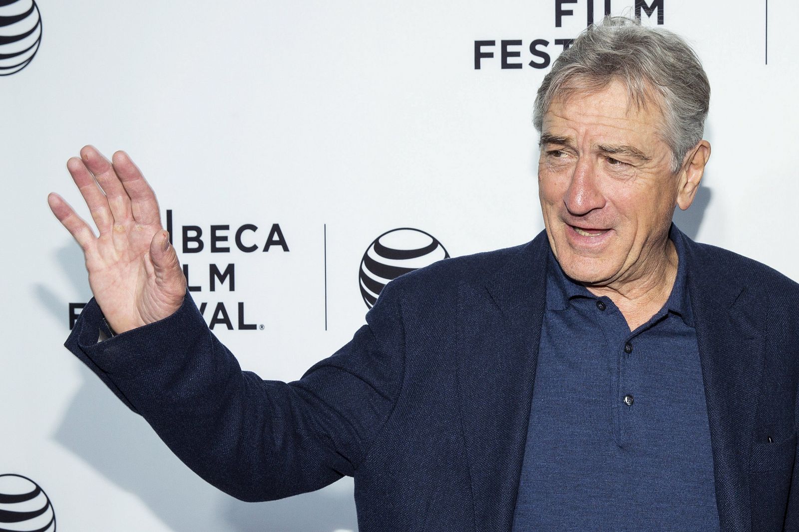 De Niro waves he arrives for the world premiere of the film "Live From New York" at the 2015 Tribeca Film Festival in New York