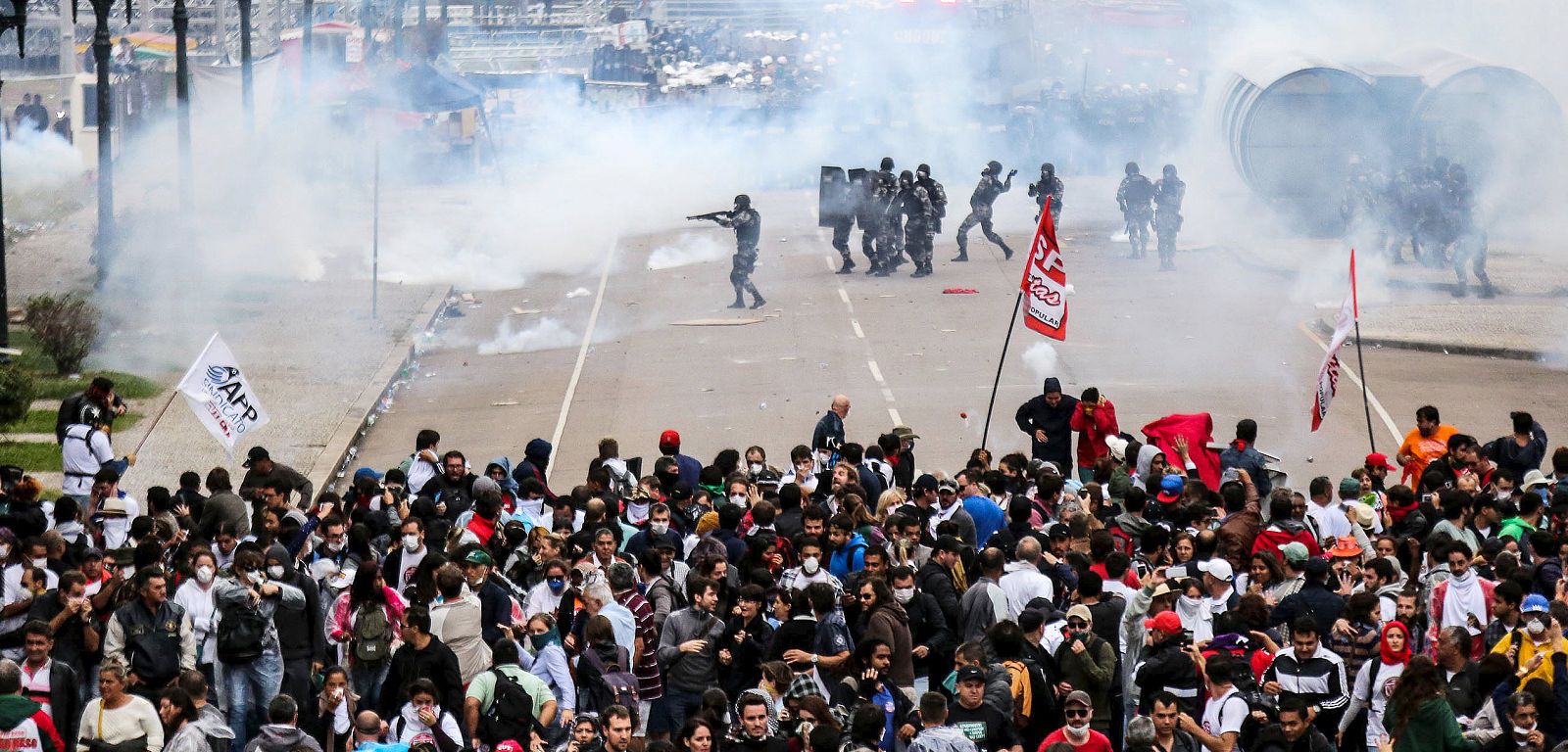 Policemen fire rubber bullets and tear gas against teachers during a protest in Curitiba