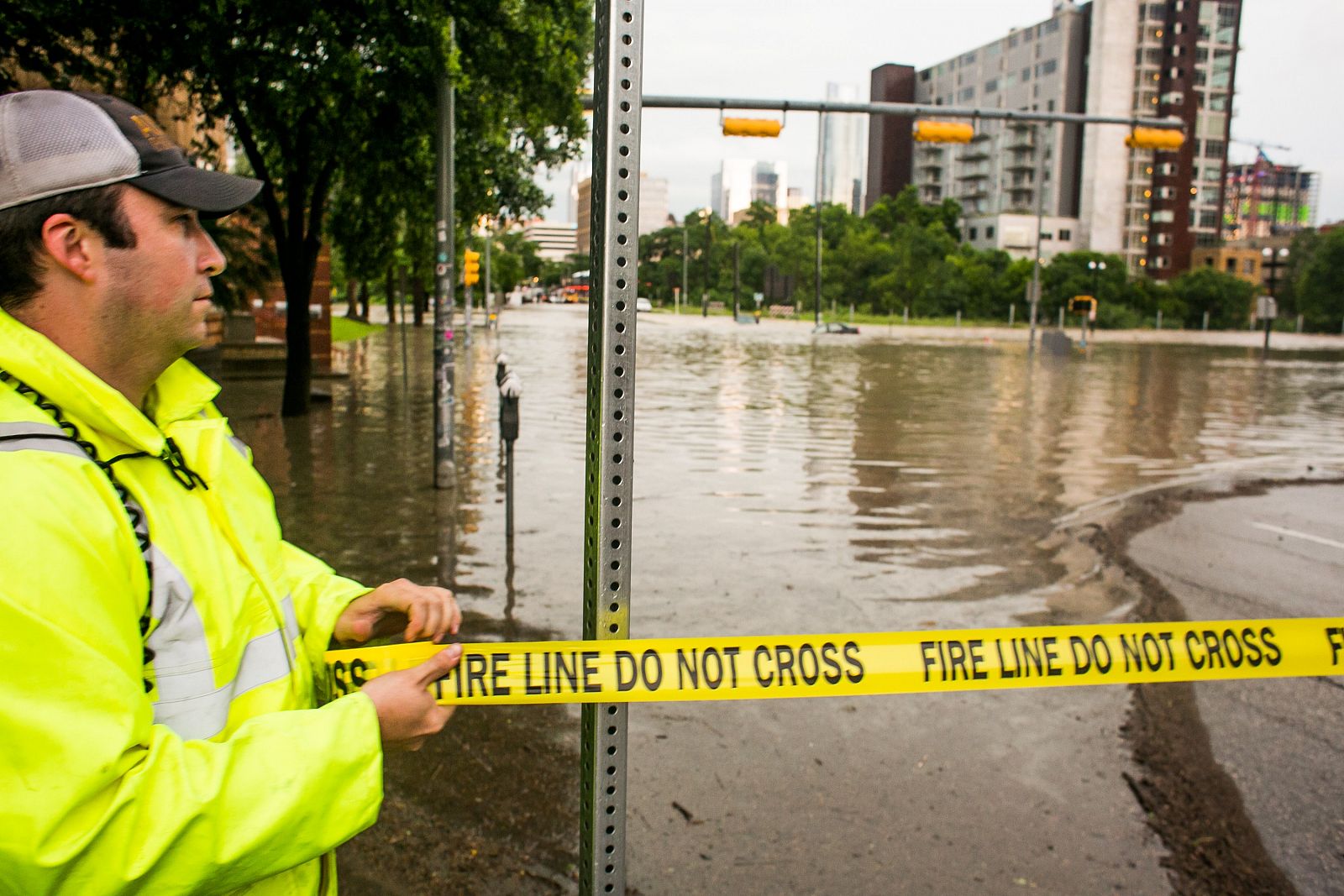 Un agente de seguridad acordona una calle inundada de Austin, Texas, tras varios días de fuertes lluvias.