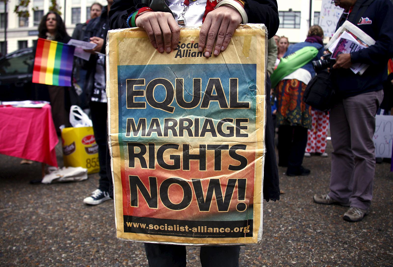 A gay rights activist holds a placard during a rally supporting same-sex marriage, in Sydney, Australia