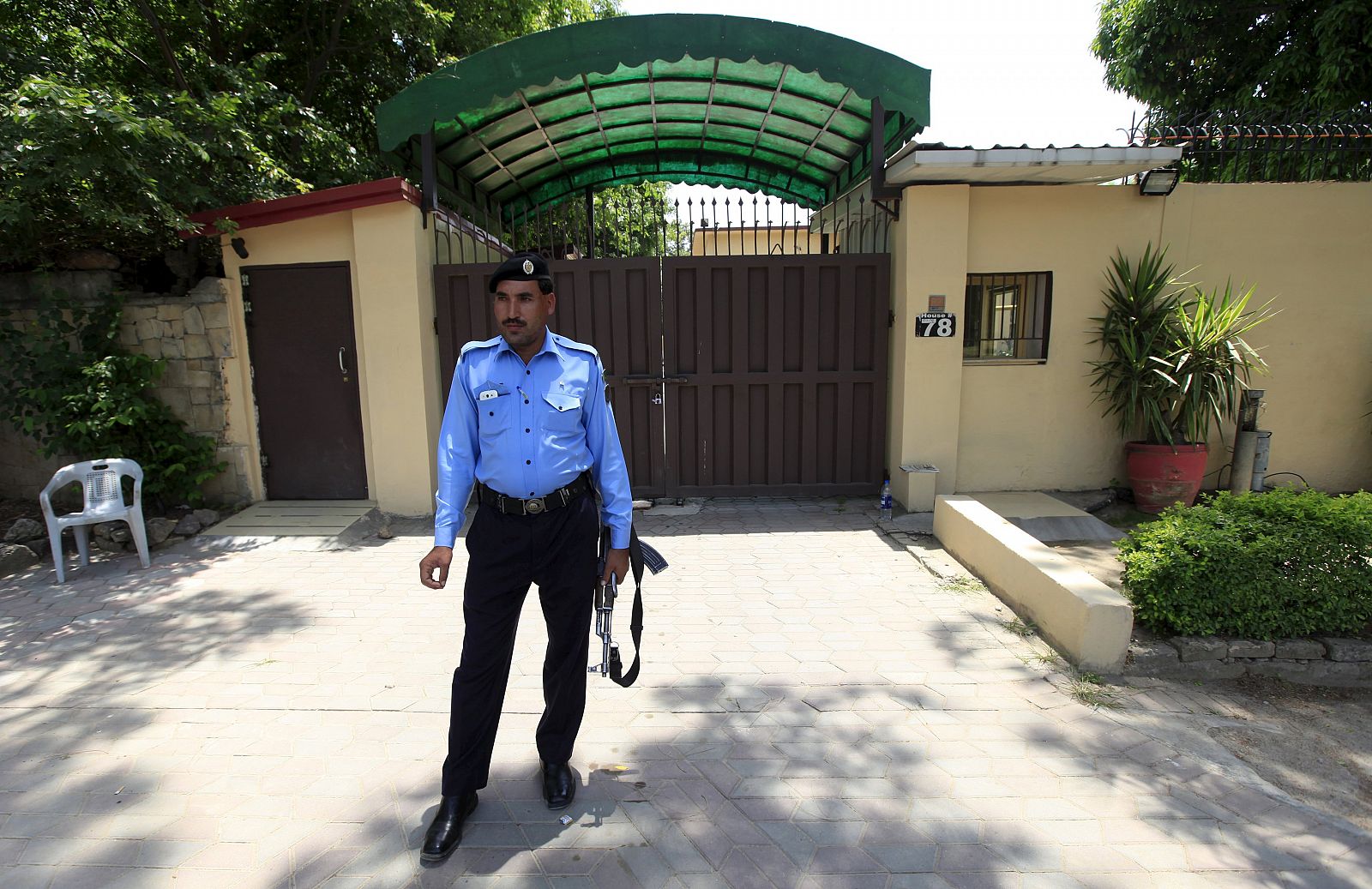 A policeman stands guard outside the Save the Children charity's office in Islamabad