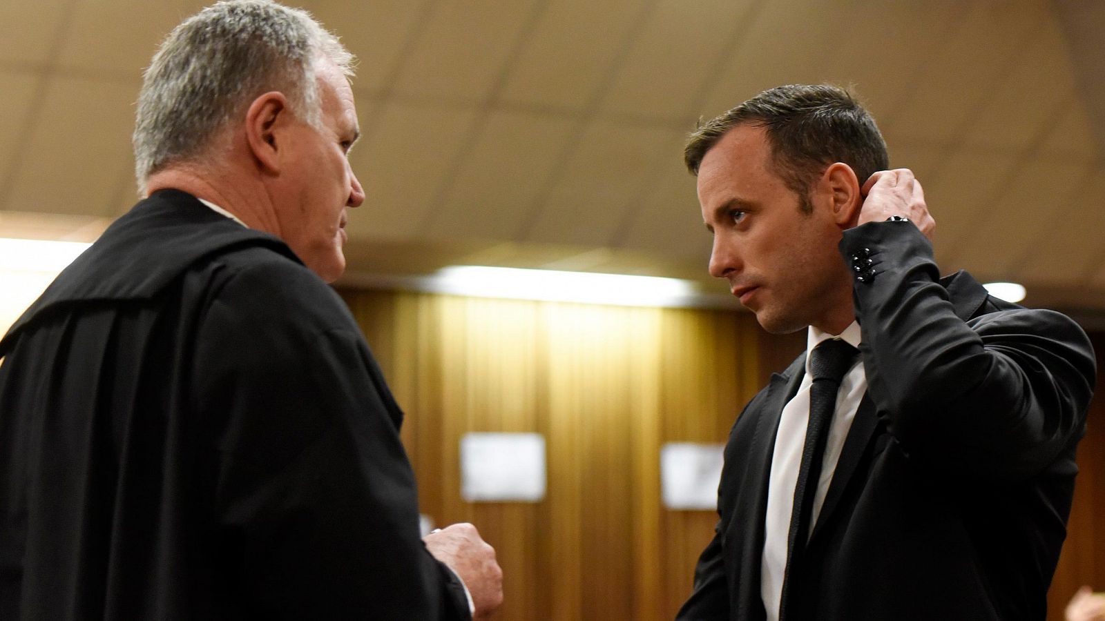 Oscar Pistorius conversa con su abogado en un momento de la vista